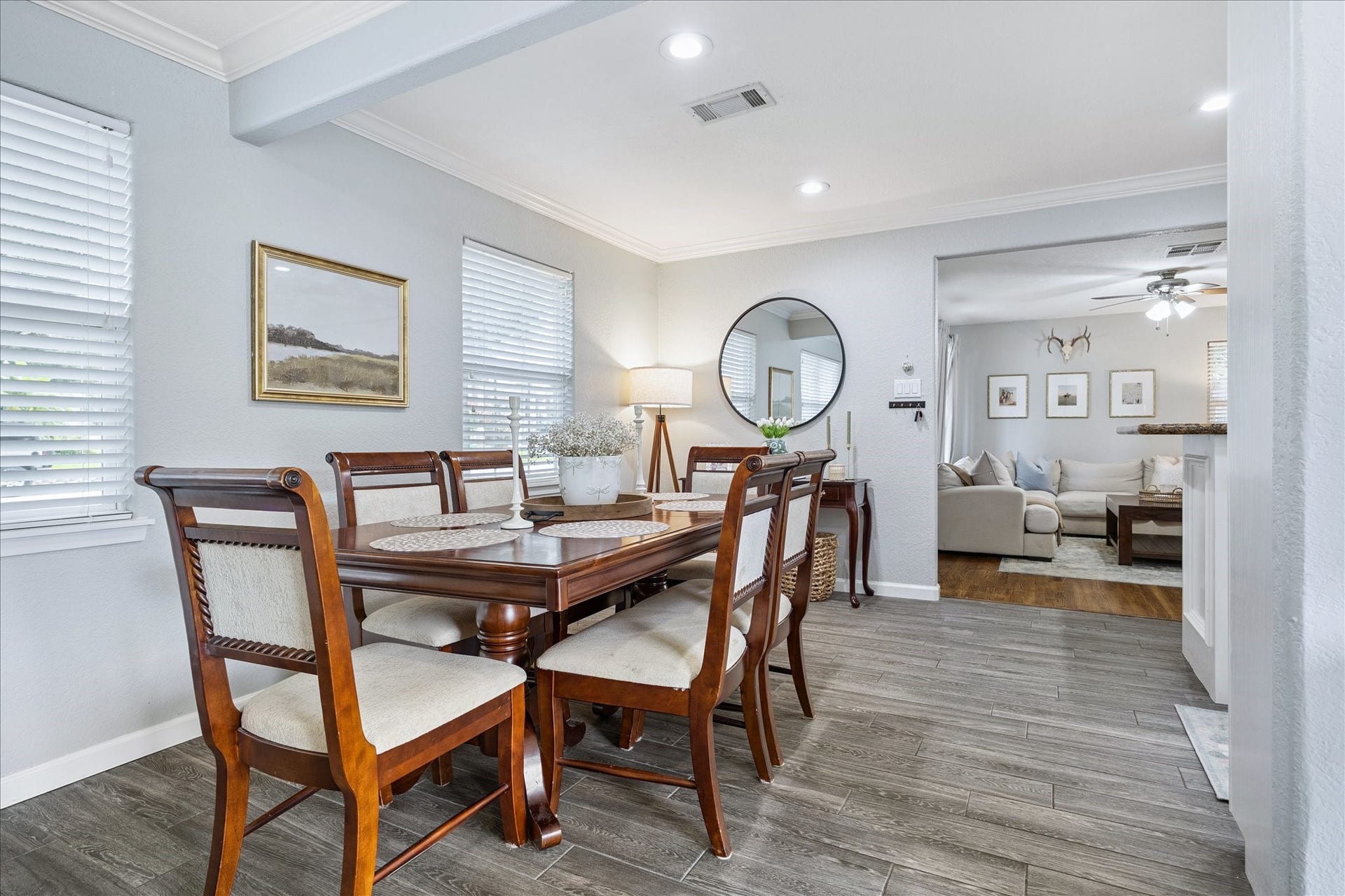 The formal dining area offers generous space for entertaining, with updated flooring, crown molding, and abundant windows.