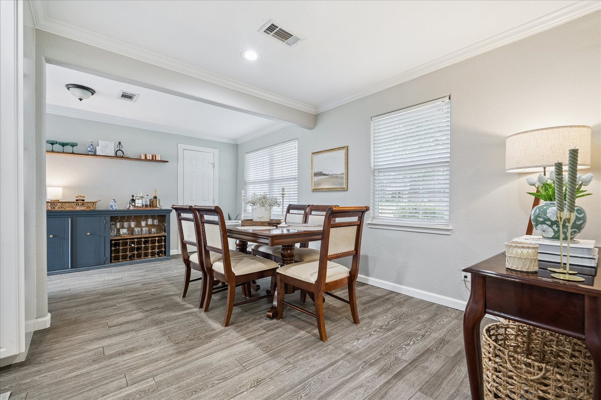 A second view of the dining room shows seamless flow into the front flex space and highlights the bar and storage area.