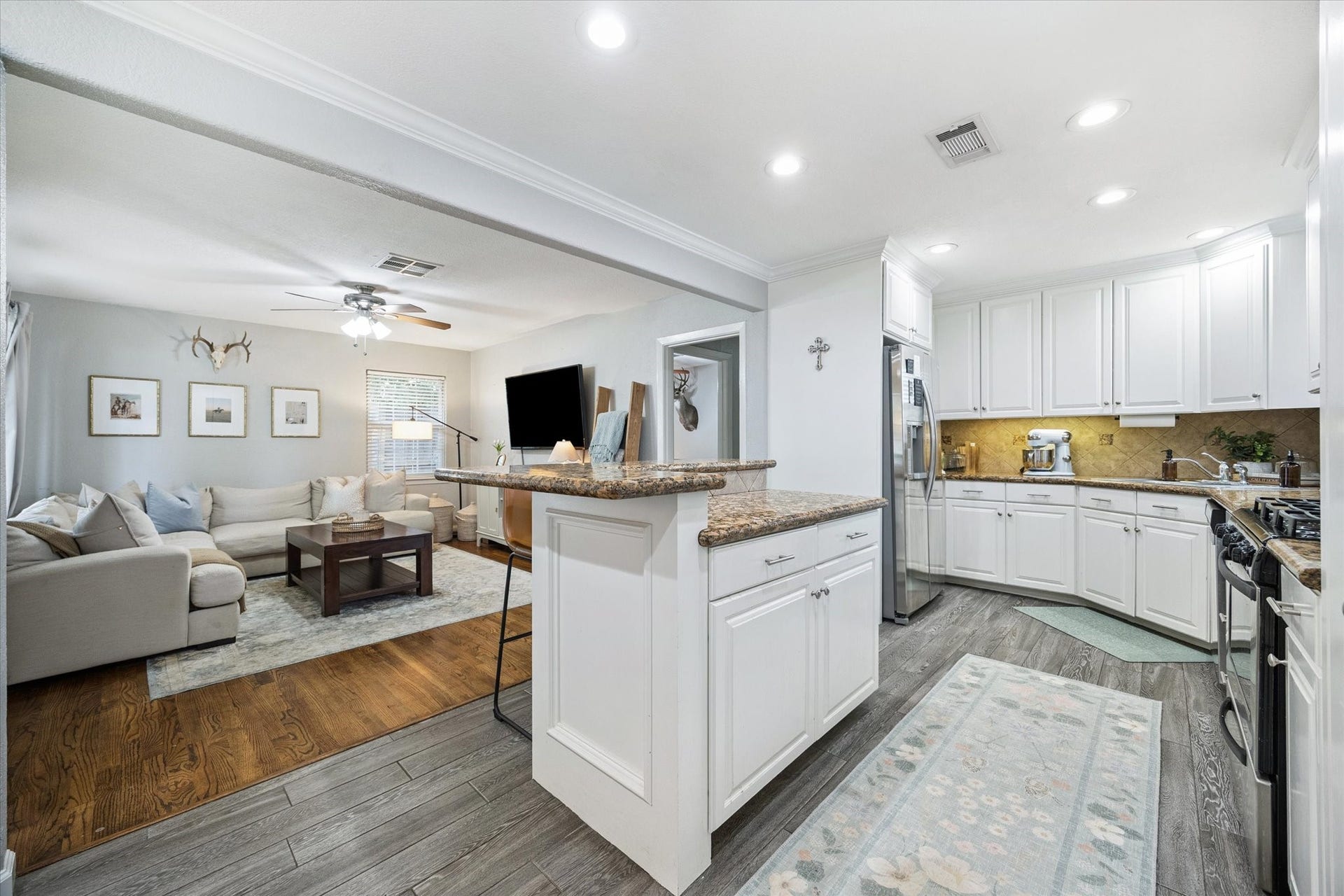 The kitchen island provides bonus prep space and storage, anchoring the open floorplan with easy flow into all main living areas.