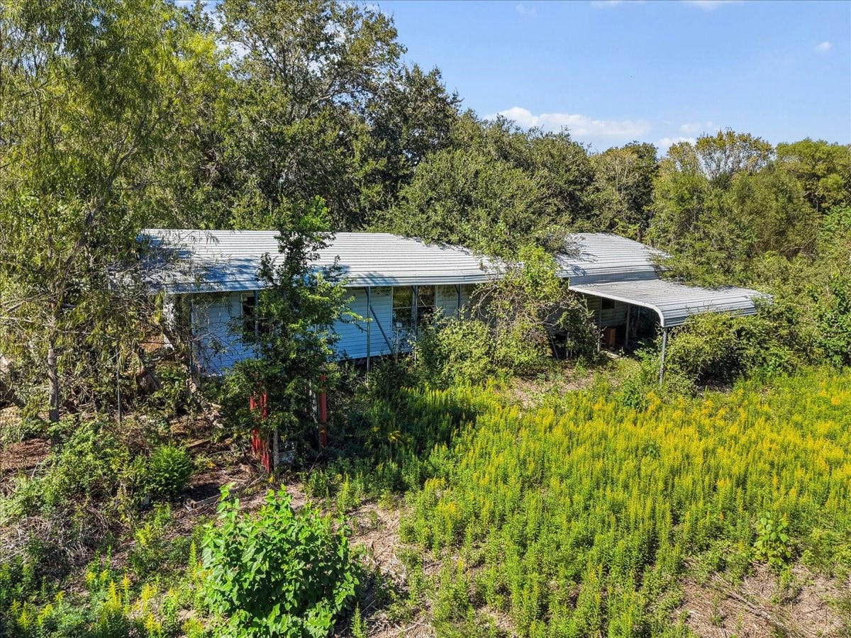 5029 1/2 Ike Franks Road, Santa Fe, TX 77517 This manufactured home on the site is uninhabitable and will need to be razed. This is a land-only purchase.