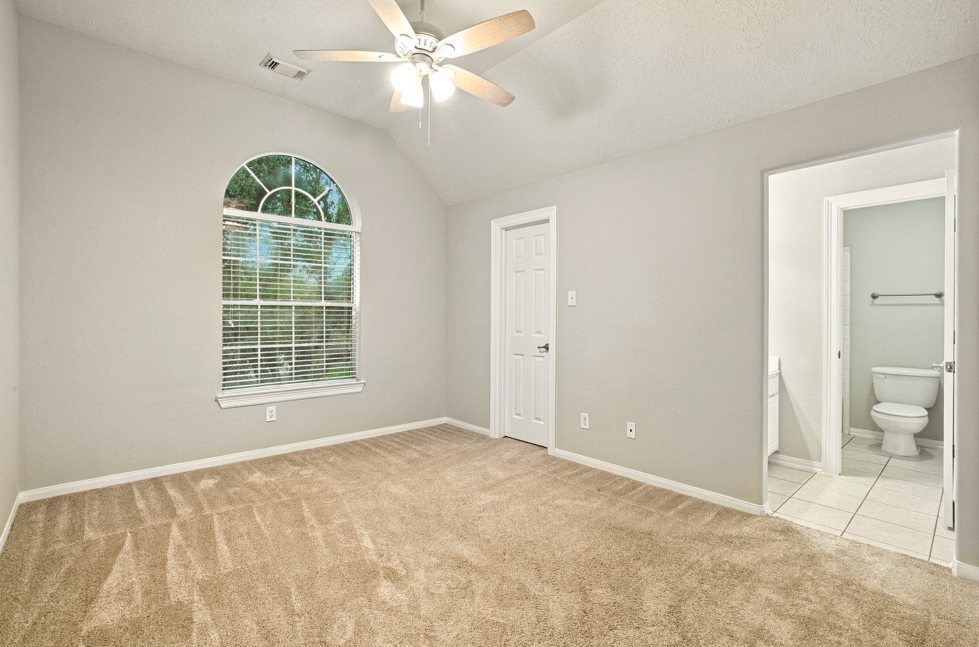 3 of 3 upstairs Secondary bedrooms featuring plush carpeting, ceiling fans, ample natural light, and flexible space to fit a variety of needs.