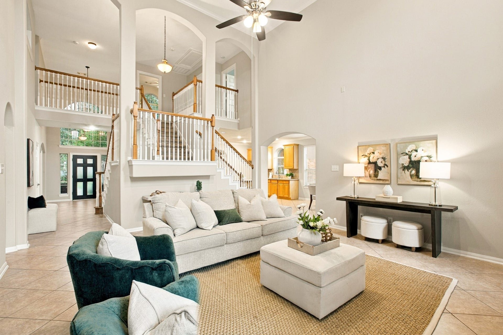 Open staircase overlooking the space. An airy, inviting layout with beautiful sightlines to the foyer and kitchen.