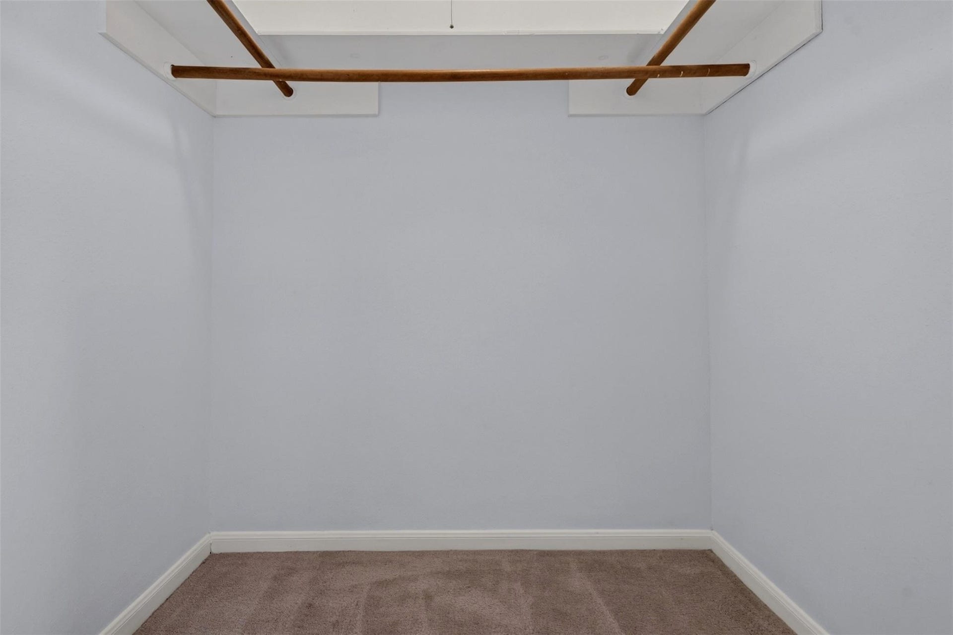 700 Thicket Lane, #304, Houston, TX 77079 Spacious walk-in closet with ample hanging space and neutral carpeting.