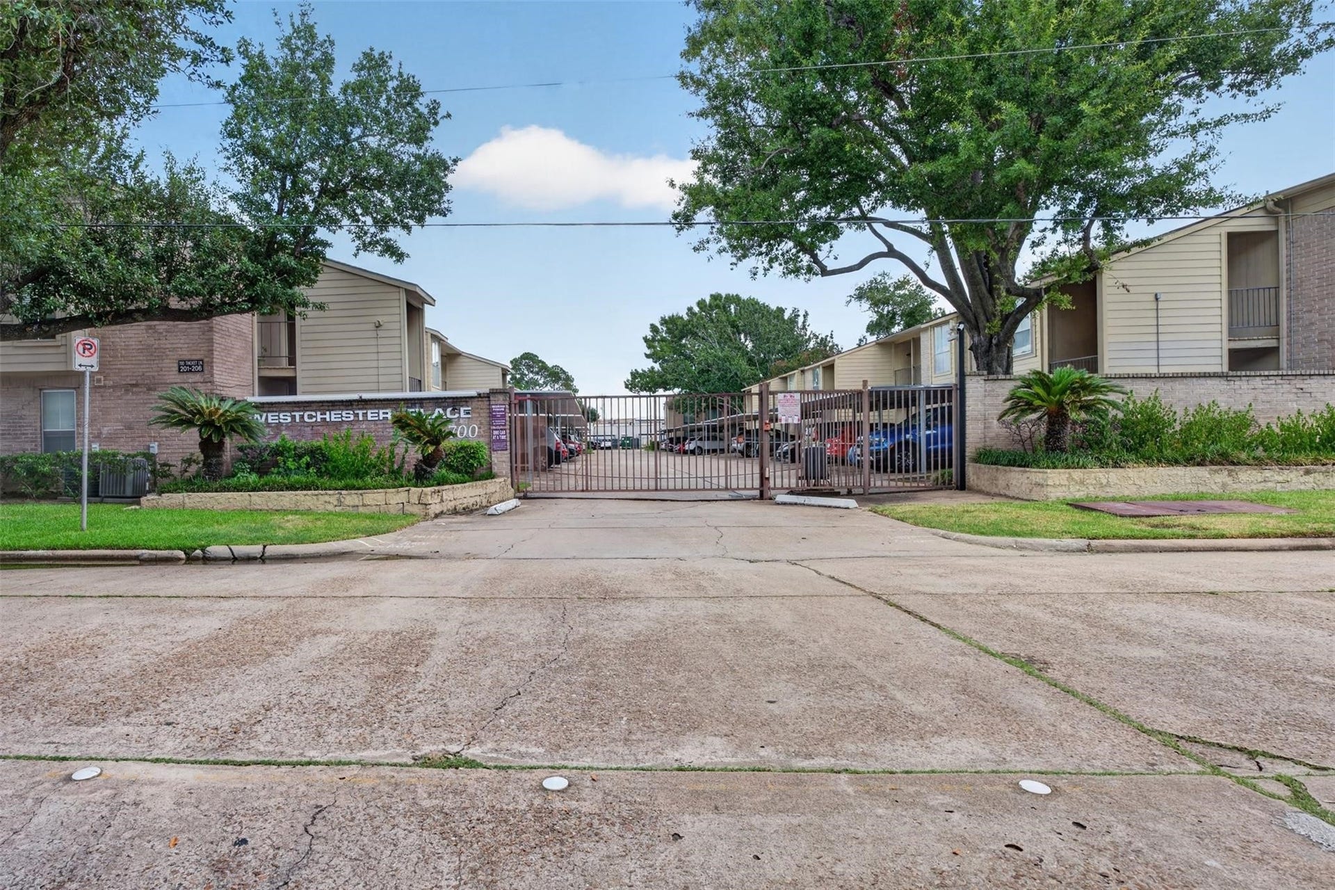 700 Thicket Lane, #304, Houston, TX 77079 Gated community entrance offering security and privacy, surrounded by well-maintained landscaping and mature trees.