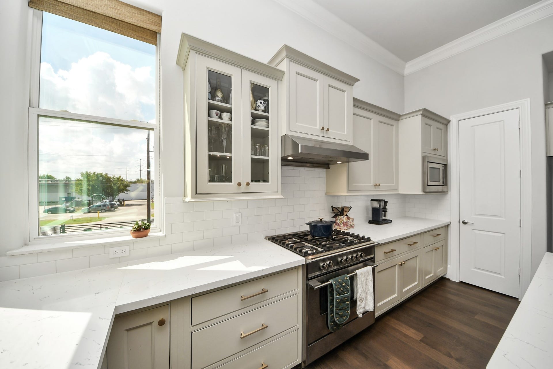Bright and airy kitchen with sleek white cabinetry, modern stainless steel appliances, and elegant quartz countertops, offering a perfect blend of style and functionality.