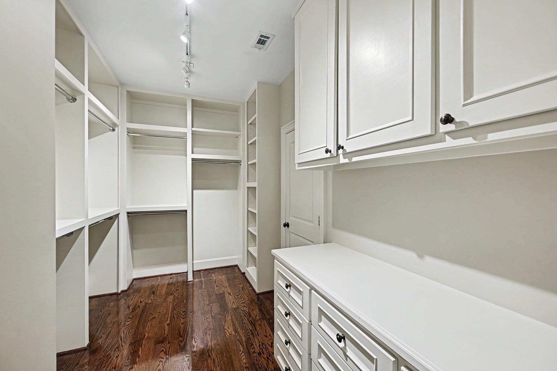 The second primary suite walk-in closet offers additional built-in storage and ample space for wardrobe essentials.