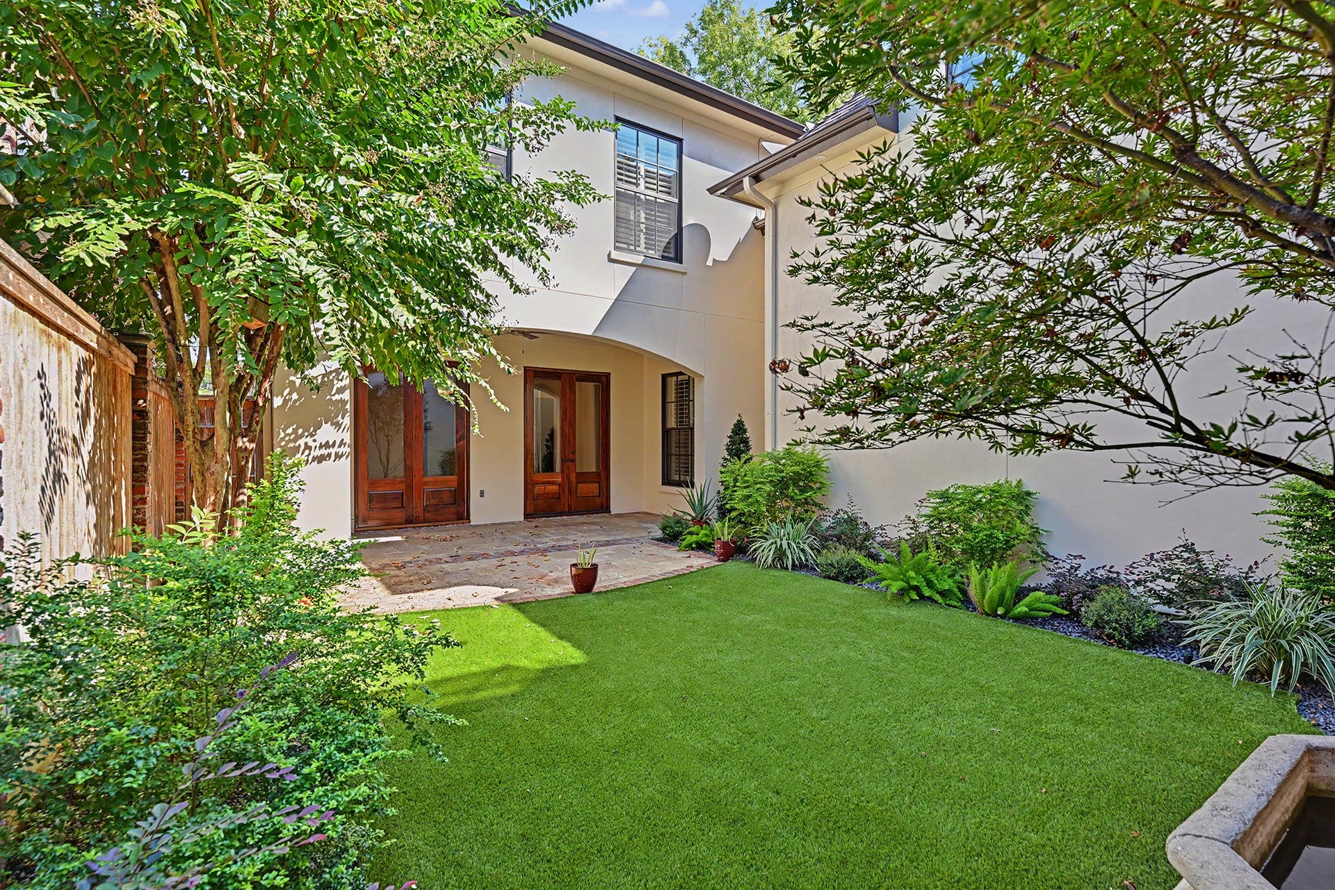 Entertain or relax outdoors in the private, fenced backyard with covered patio and a lovely landscaped setting.