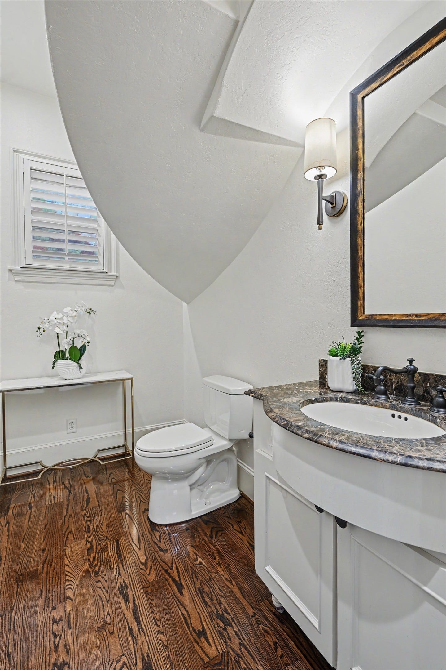 Powder room off the entry with classic finishes.