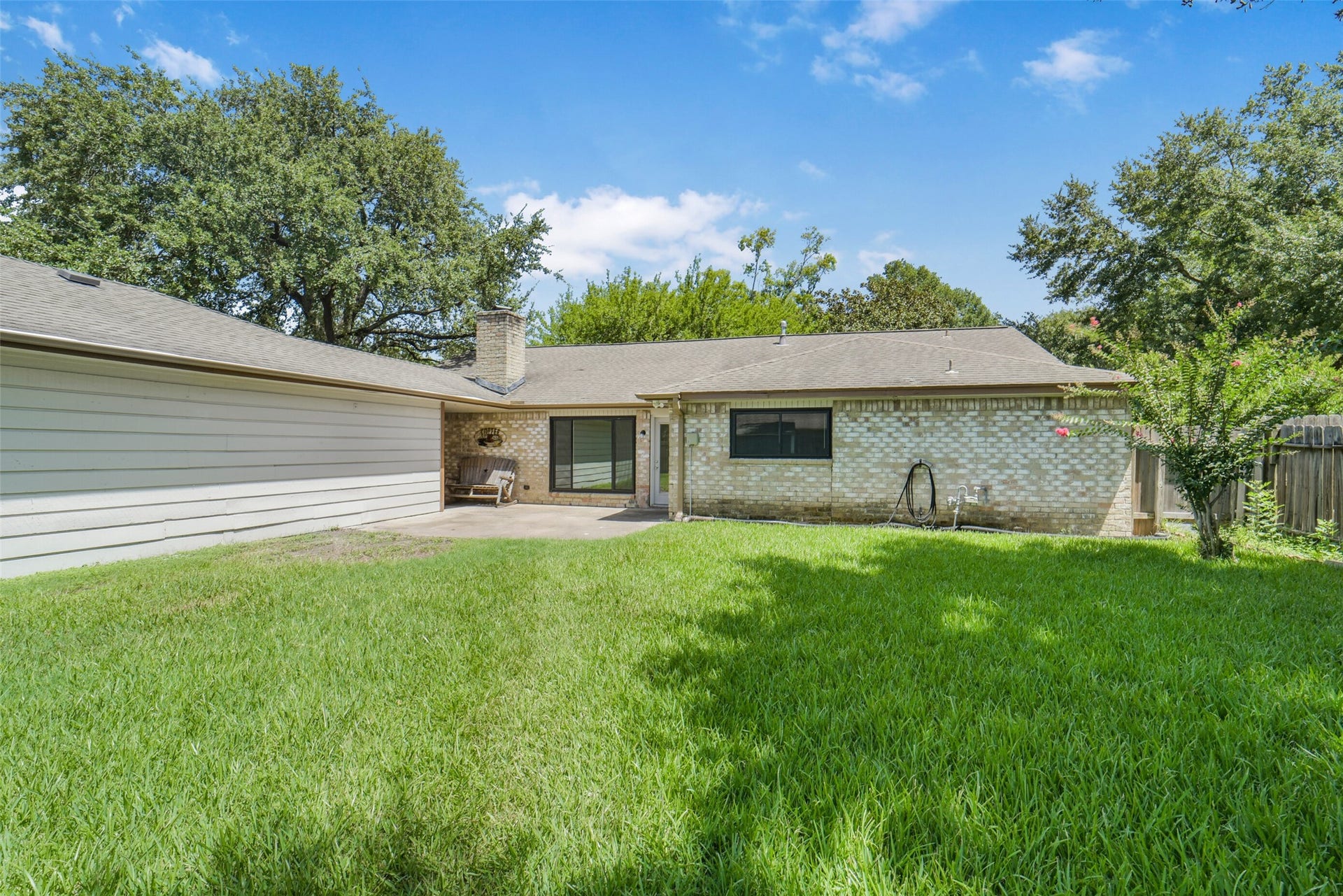 Additional view of the large backyard with mature trees and plenty of green space for a pool or play area for you to enjoy.