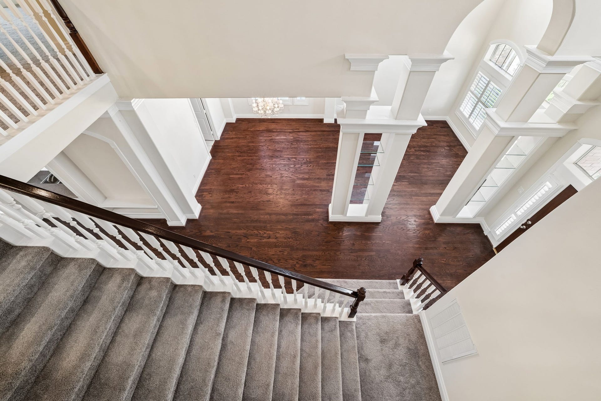 Elegant staircase with plush carpeting leads to the second floor with four bedrooms, a game room, balcony and bathrooms.