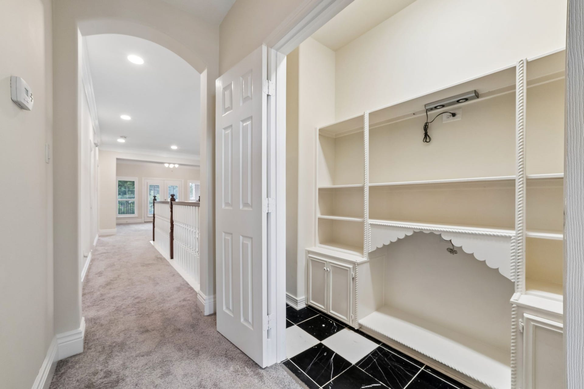 Convenient upstairs built-in study nook in Bedroom#4, featuring custom shelving, cabinetry, and a dedicated workspaceperfect for a home office, homework station, or organization area.