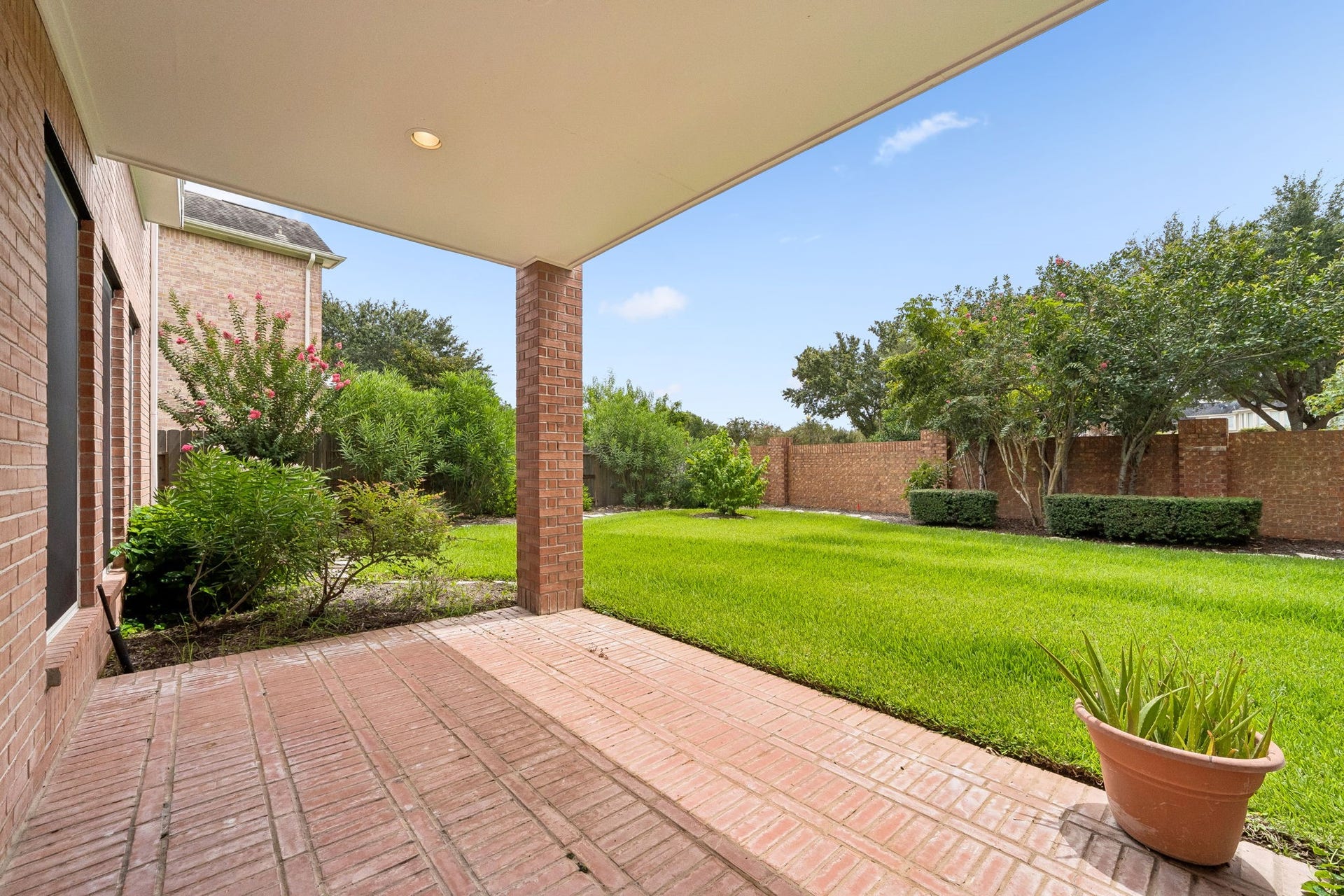 Expansive, lush backyard with covered patio perfect for outdoor enjoyment and relaxation.