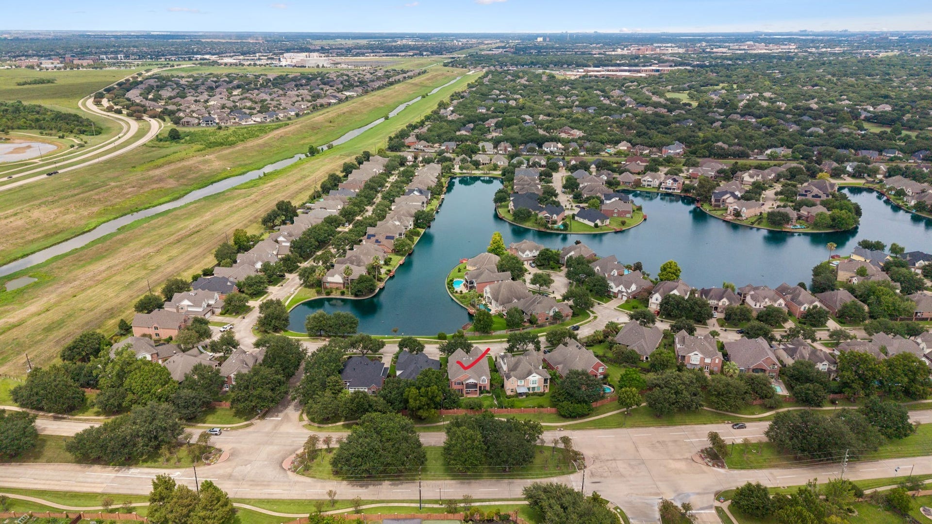 Nestled in a picturesque lakeside community, this home offers serene water views and lush greenery, providing a peaceful and inviting neighborhood ambiance.