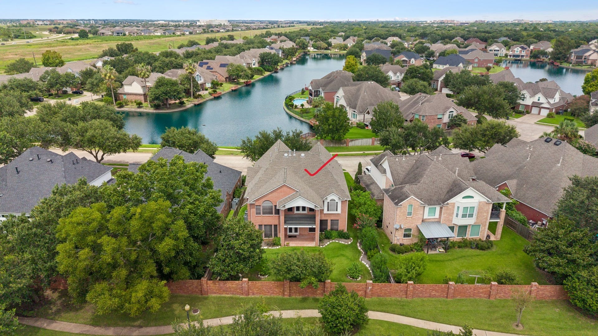 Beautiful Waterview home featuring a spacious backyard, lush greenery, and a serene neighborhood setting with easy access to the water.