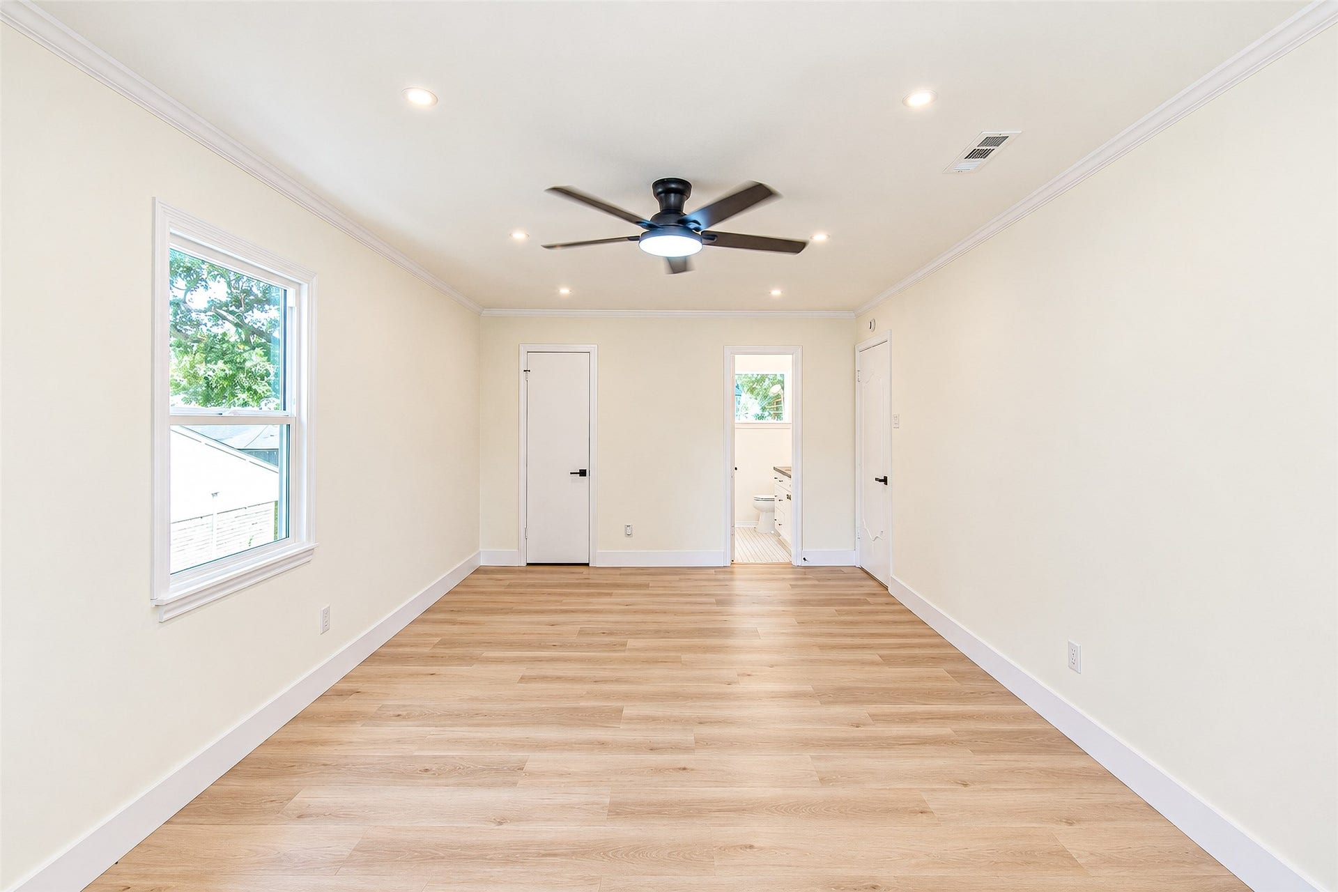 10610 Overbrook Lane, Houston, TX 77042 Experience the spacious elegance of Bedroom 3, featuring sleek vinyl floors, abundant natural light, and a modern ceiling fan for ultimate comfort.