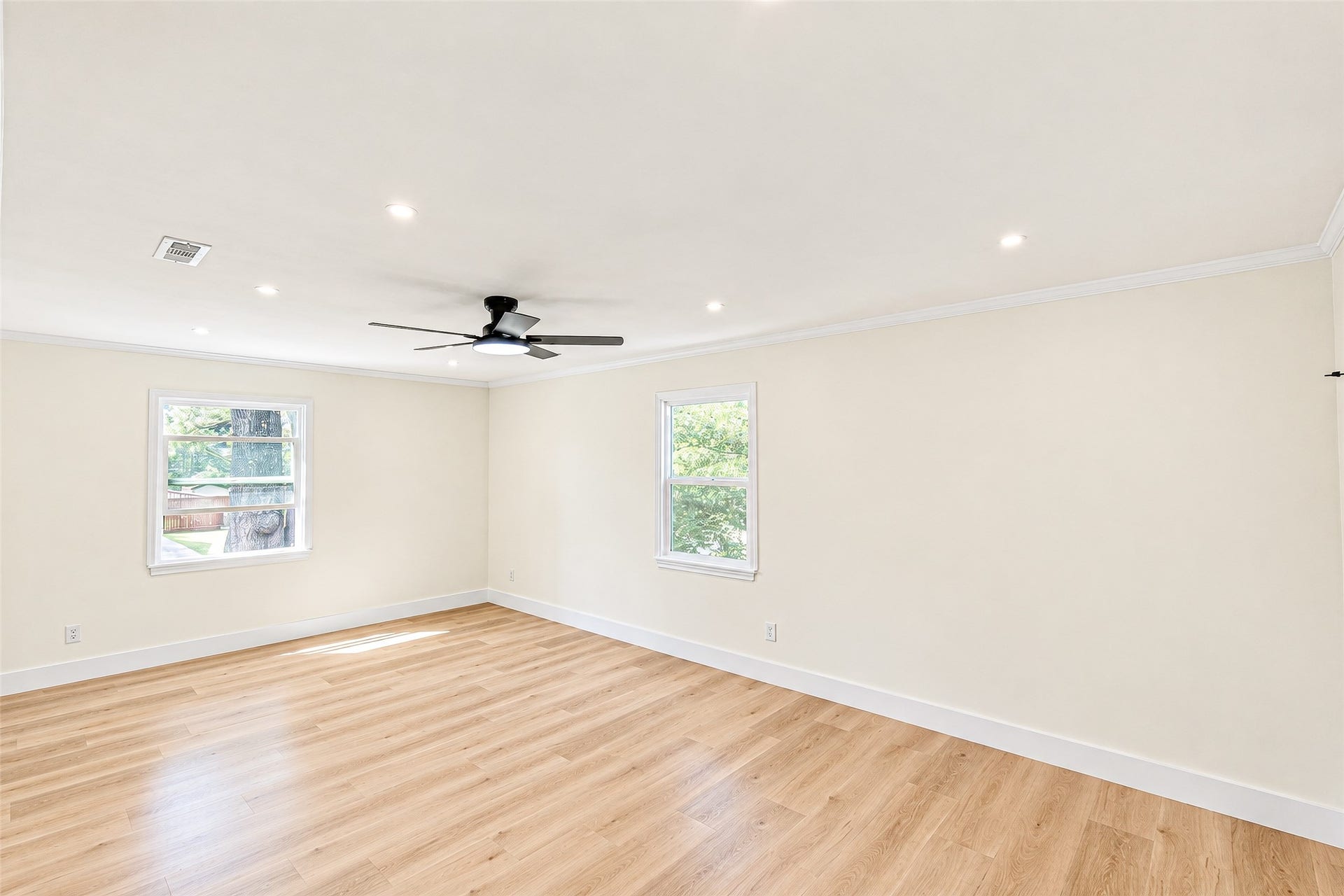 10610 Overbrook Lane, Houston, TX 77042 Bedroom 2 offers a bright and airy retreat with elegant vinyl floors, ample natural light, and a modern ceiling fan for comfort.