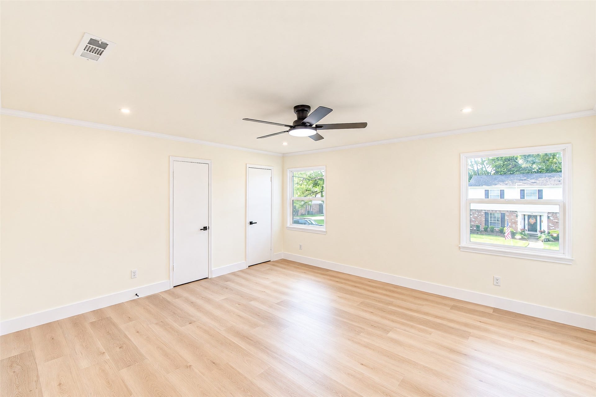 10610 Overbrook Lane, Houston, TX 77042 Spacious and sunlit, the primary bedroom offers sleek vinyl floors, fresh neutral walls, and large windows with views of the charming neighborhood.