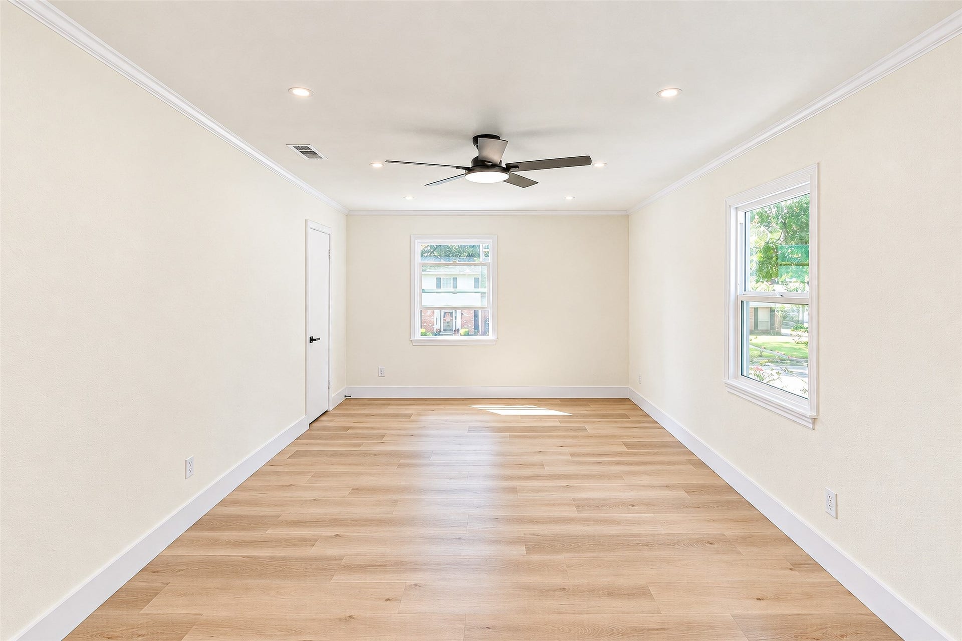 10610 Overbrook Lane, Houston, TX 77042 Experience tranquility in Bedroom 2, featuring ample natural light, elegant vinyl floors, and a modern ceiling fan for ultimate comfort.