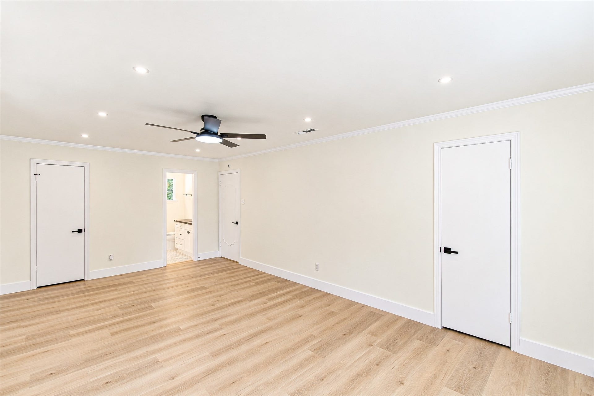10610 Overbrook Lane, Houston, TX 77042 Spacious and inviting, Bedroom 3 features sleek vinyl flooring, recessed lighting, and a modern ceiling fan, creating a perfect blend of comfort and style.
