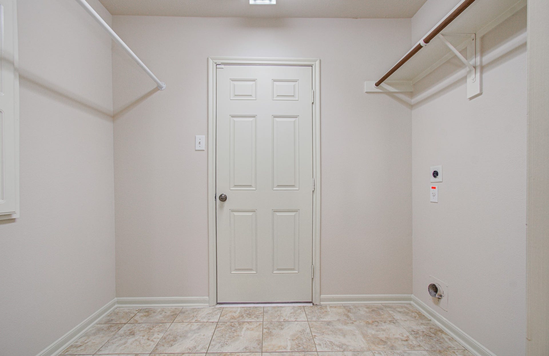 12808 Brook Arbor Court, Pearland, TX 77584 Spacious laundry room with tiled flooring, ample shelving, and space for washer and dryer installation.