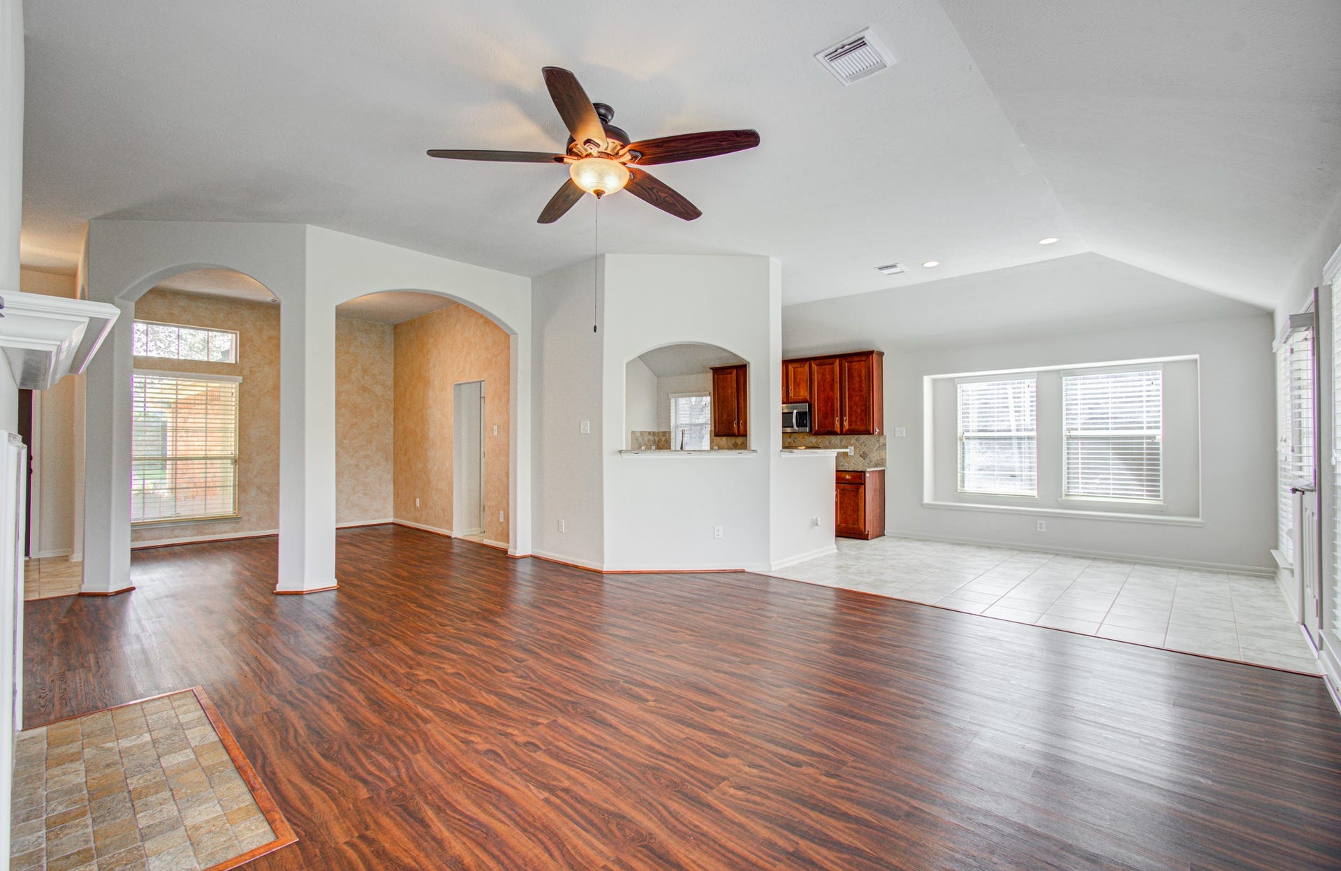 12808 Brook Arbor Court, Pearland, TX 77584 Spacious open-concept living area seamlessly connecting to a modern kitchen with rich cabinetry and a cozy dining nook.