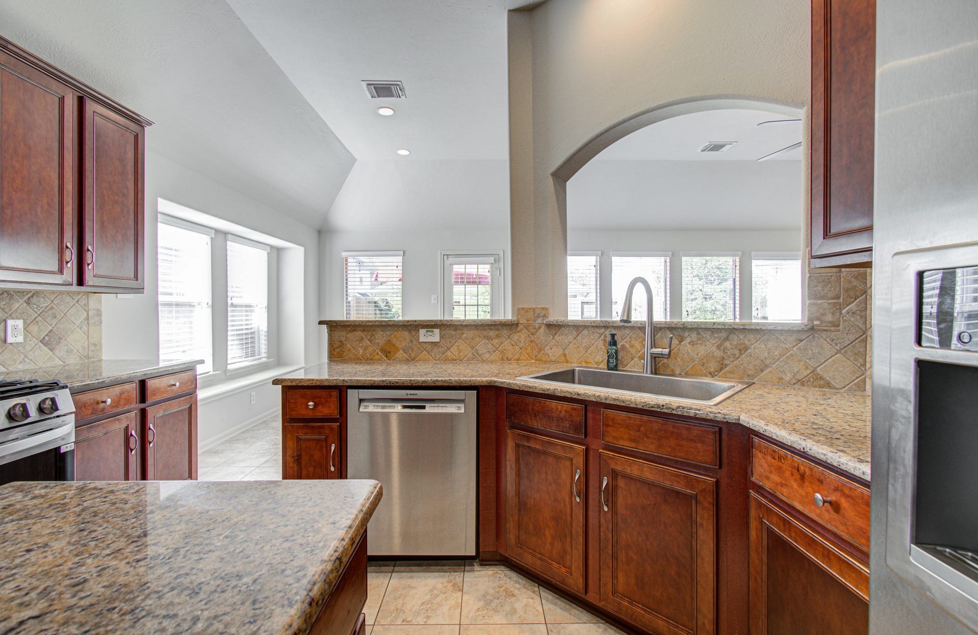 12808 Brook Arbor Court, Pearland, TX 77584 The open layout features ample natural light and a charming arched passthrough.