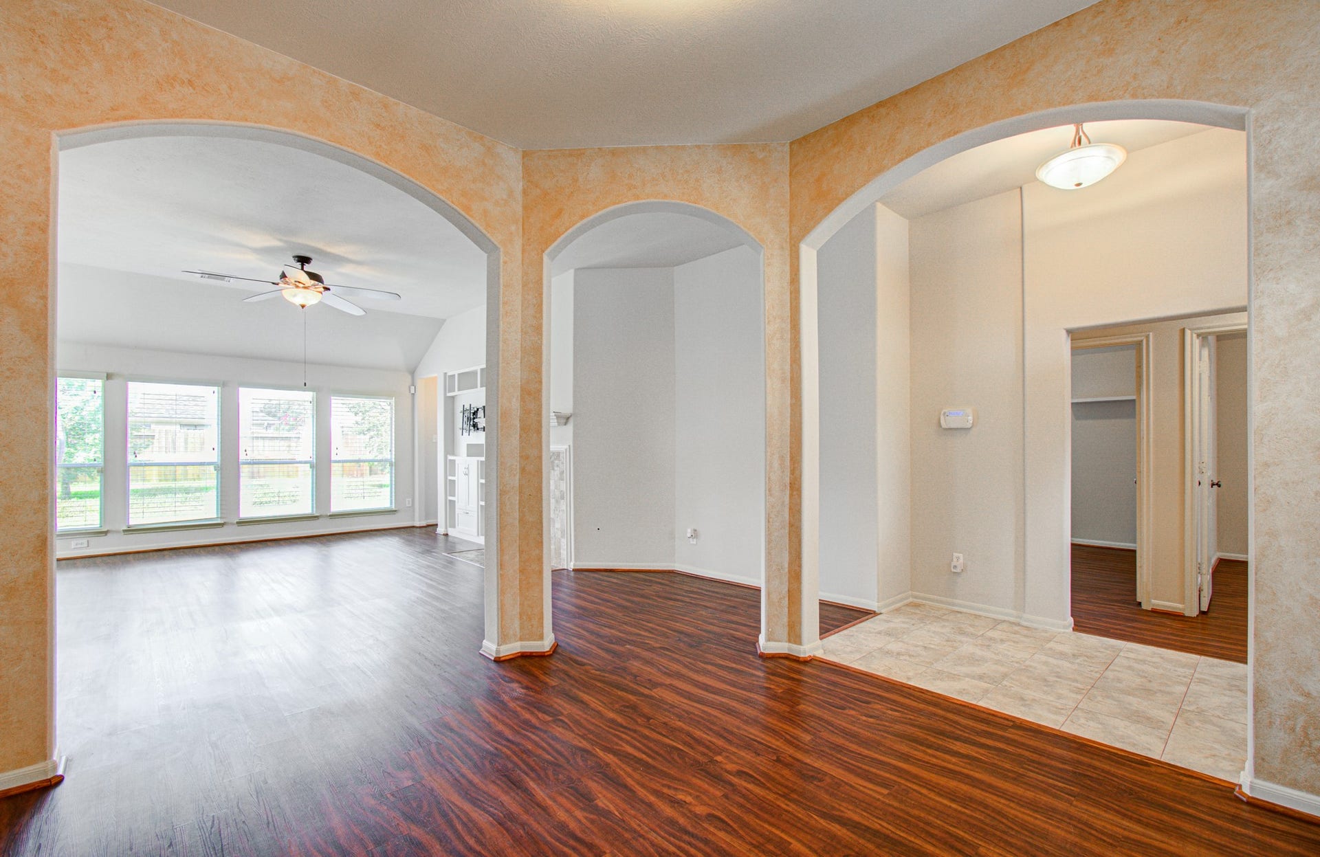 12808 Brook Arbor Court, Pearland, TX 77584 Elegant arched doorways and large windows provide ample natural light for this dining/sitting area.