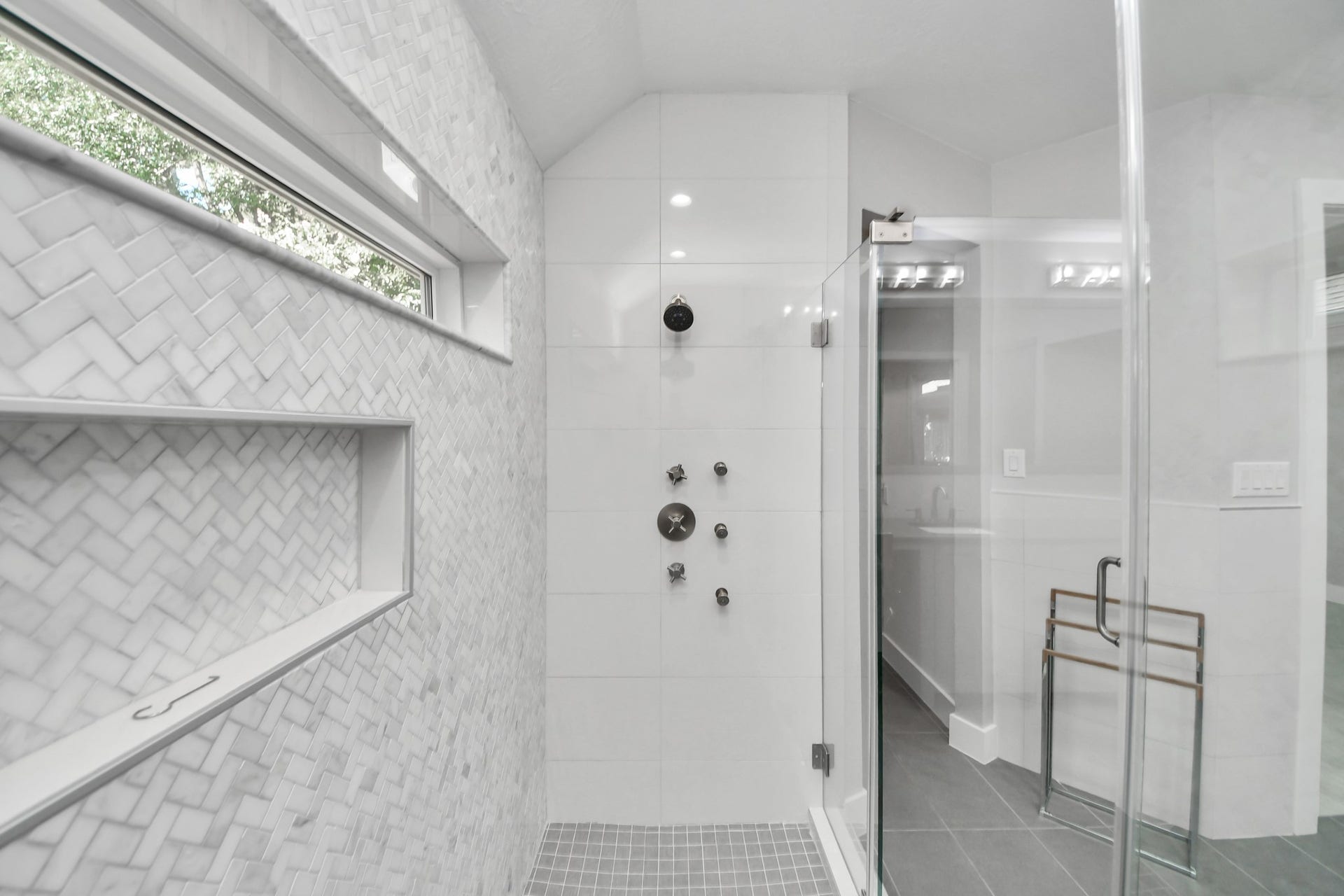 Luxurious custom shower in the primary bedroom featuring body sprayers, wands and custom set temperature controls on both sides for the perfect shower, every time!