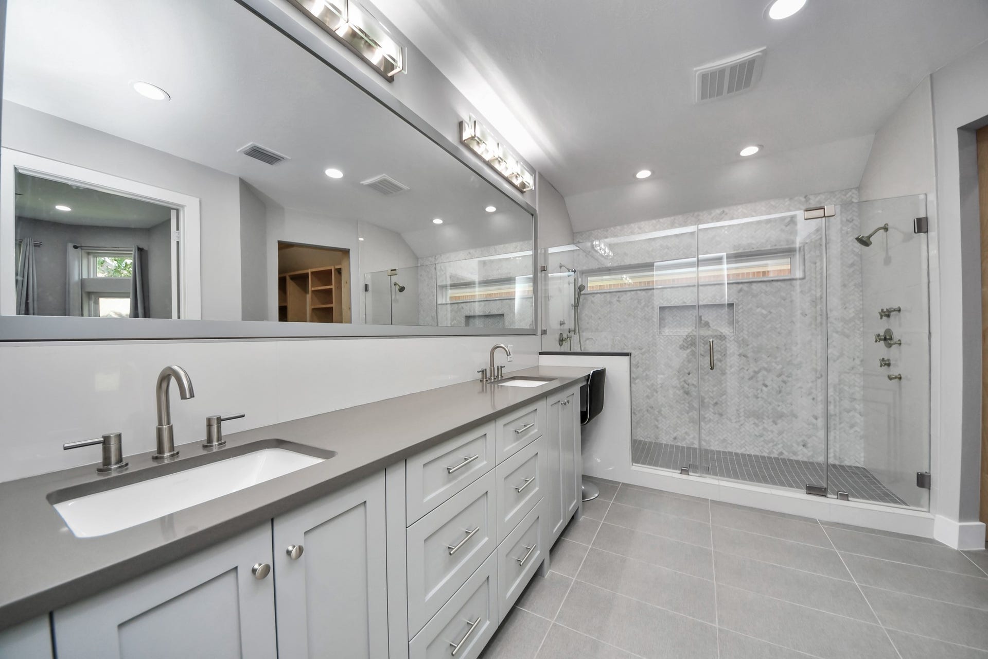Luxurious custom shower in the primary bedroom featuring body sprayers, wands and custom set temperature controls on both sides for the perfect shower, every time!