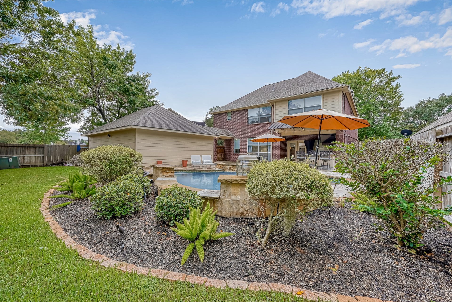 7707 Stone Arbor Drive, Sugar Land, TX 77479 And yesyou still have grass! Beyond the pool & beautifully landscaped beds, the backyard offers a separate grassy area behind the detached garage, providing welcome green space for pets, play or gardening. Mature landscaping surrounds the pool area without consuming the entire yarda great combination of backyard oasis + usable lawn space.