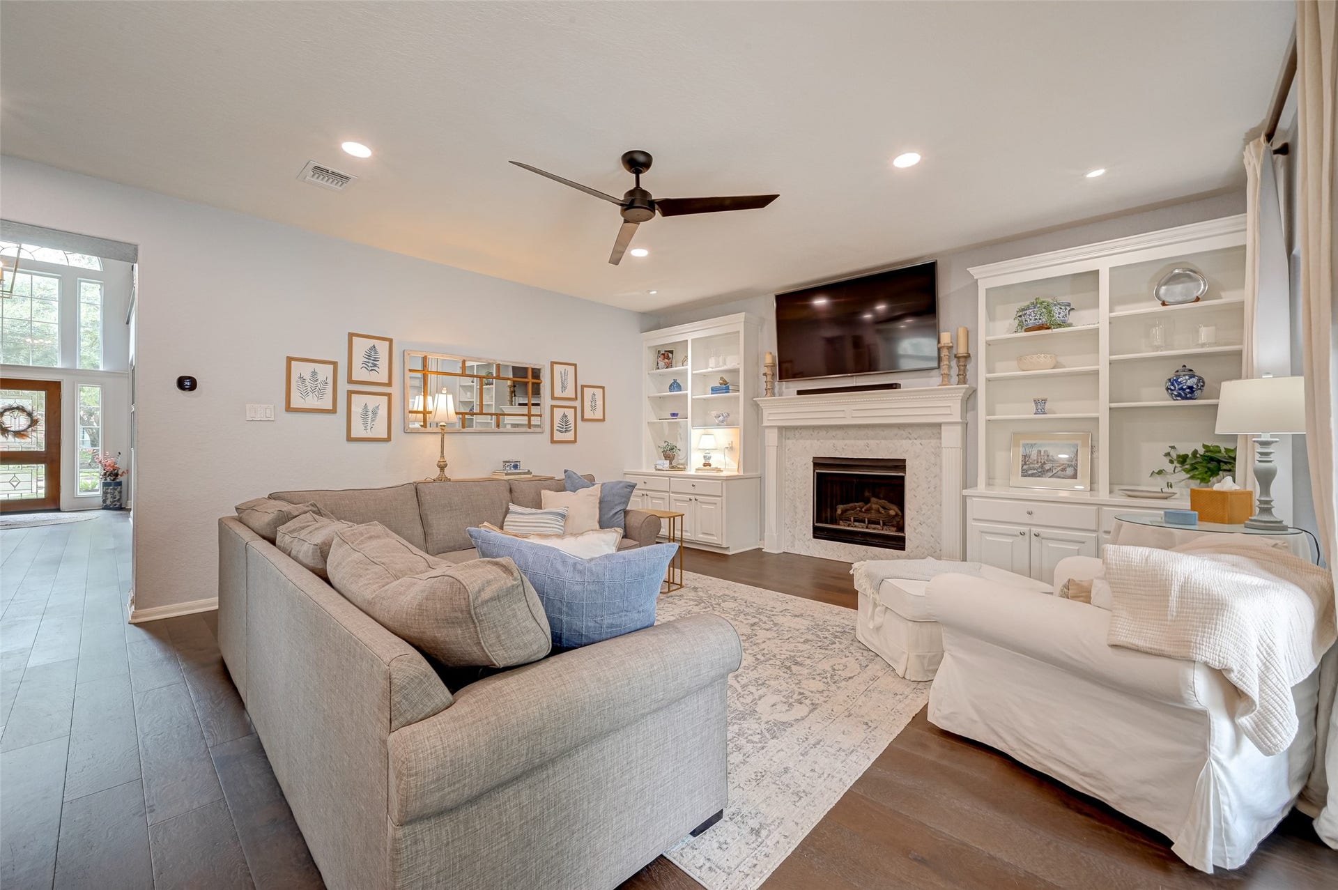 7707 Stone Arbor Drive, Sugar Land, TX 77479 Every great family room needs a focal point, and this one delivers! A gas-log fireplace is framed by custom built-ins offering wonderful space for books, family photos, favorite collections, and tucked-away storage below. Theres even room above the mantel for the big screenmovie night, game day, or a quiet evening by the fire...youre covered.