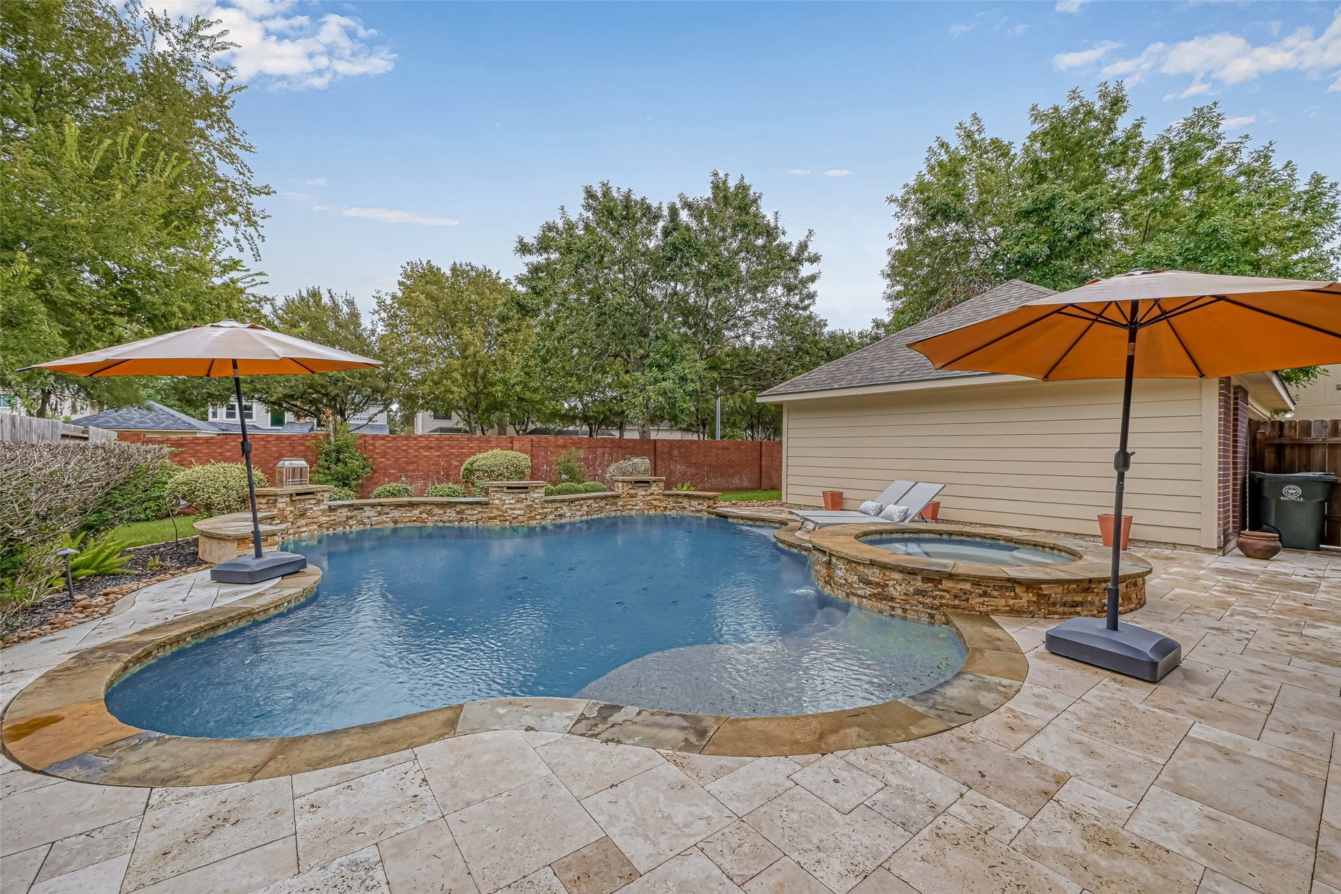 7707 Stone Arbor Drive, Sugar Land, TX 77479 WAIT UNTIL YOU SEE THE BACKYARD! Your own private oasis features a heated pool & spa with PebbleTec finish, waterfalls & flagstone accents, surrounded by an expansive Travertine deck with plenty of room for lounging & entertaining. And theres morea covered outdoor kitchen with gas grill & bar seating is just steps away. Pool parties, cookouts or quiet weekends at home...this backyard was made to be enjoyed!