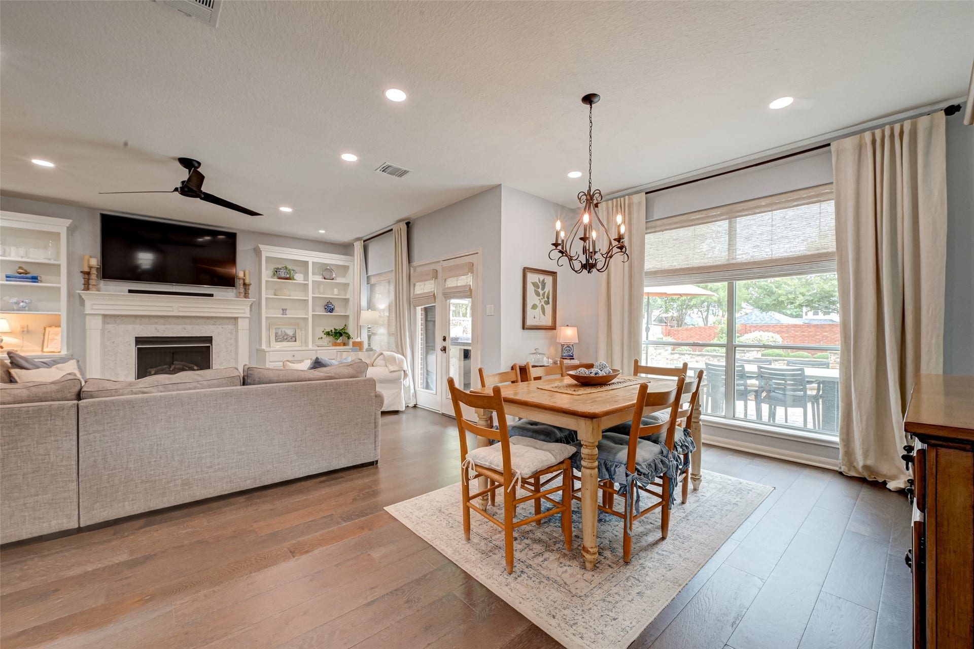 7707 Stone Arbor Drive, Sugar Land, TX 77479 Breakfast room with a backyard view! This light-filled breakfast area enjoys a large window overlooking the backyard oasis, while nearby French doors lead to the covered outdoor kitchen, heated pool & spa. The open connection to the family room keeps everyone togetherwhether its morning coffee, family meals, or keeping an eye on the kids while theyre outside playing.