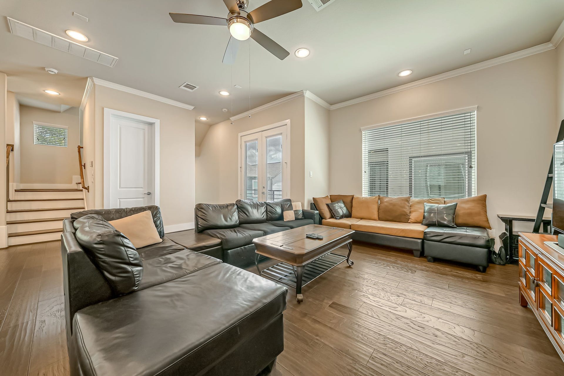 5916 Petty Street, #A, Houston, TX 77007 Spacious living area with French doors opening to the private balcony, offering additional indoor-outdoor living space.