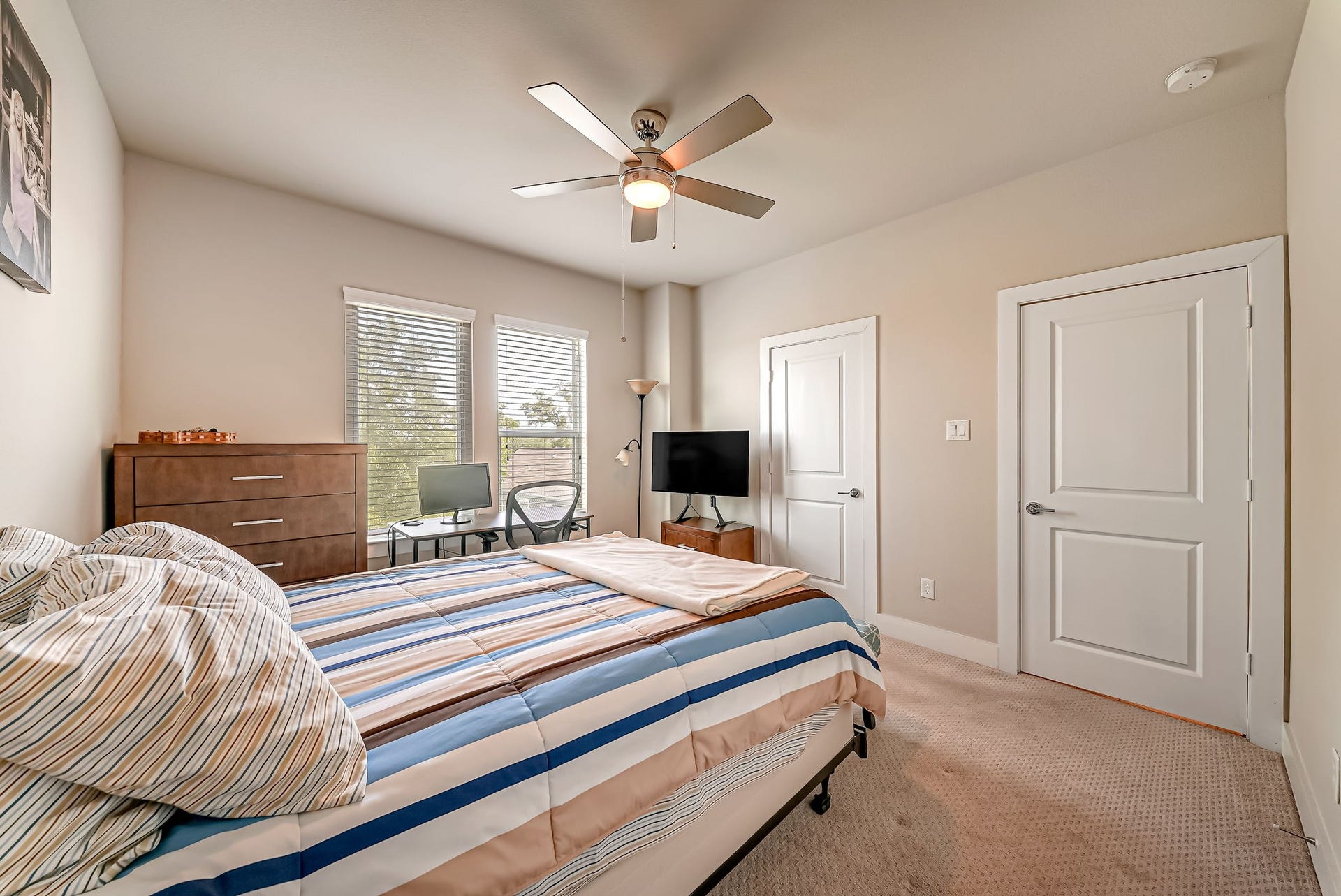 5916 Petty Street, #A, Houston, TX 77007 Secondary bedroom with large windows, treetop views, and ample closet space.