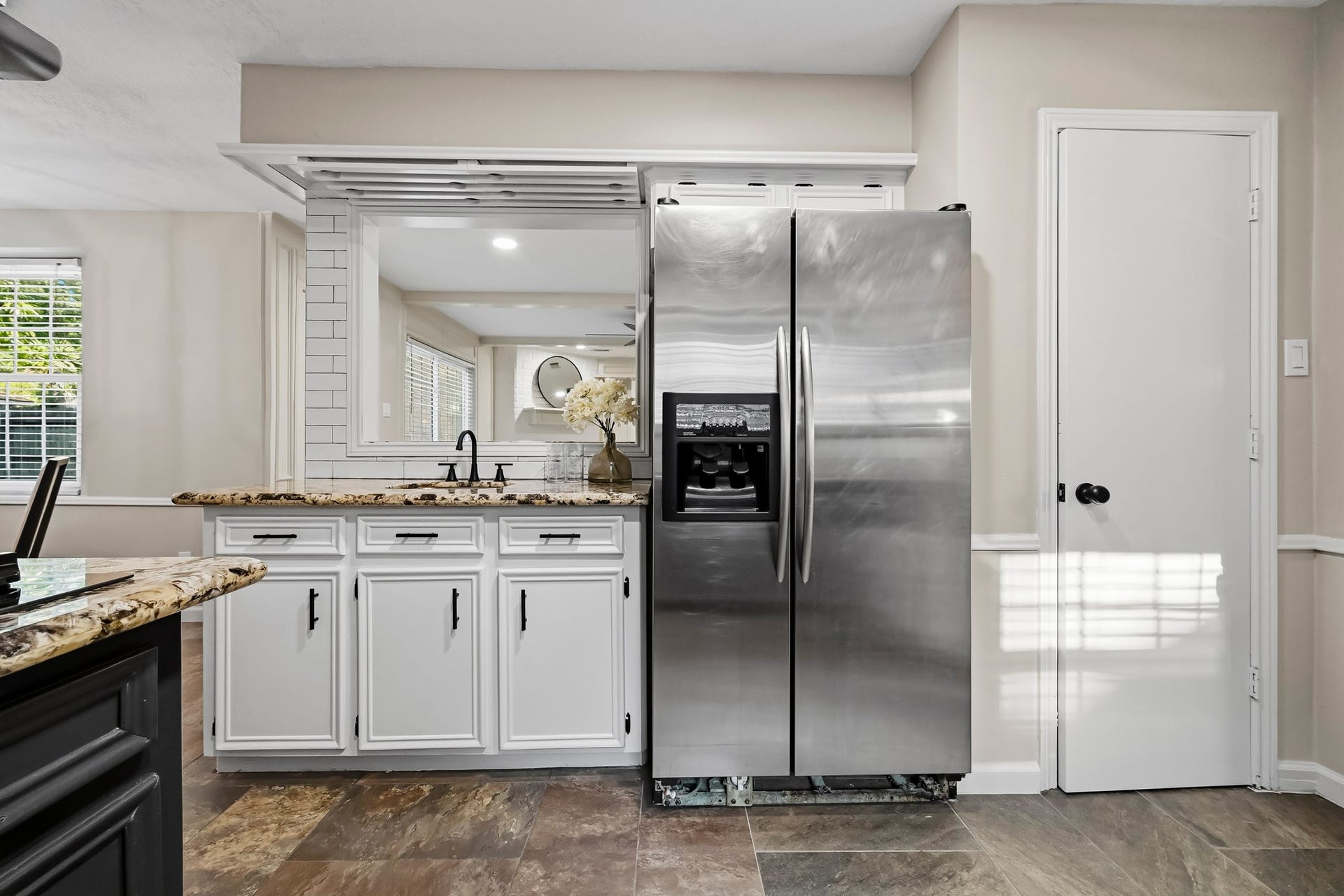 6714 Brittany Park Lane, Houston, TX 77066 Modern kitchen featuring sleek stainless steel appliances, granite countertops, and crisp white cabinetry, offering a sophisticated and functional space.