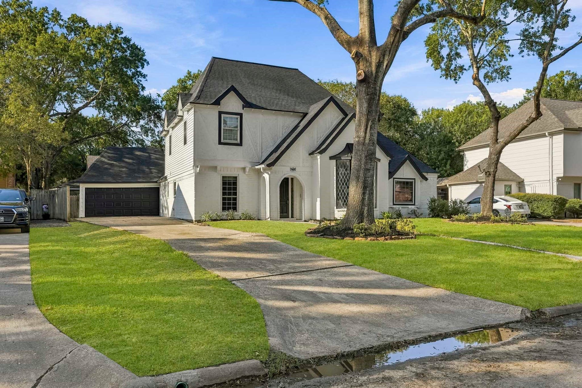 6714 Brittany Park Lane, Houston, TX 77066 Featuring a spacious driveway, lush green lawn, and mature trees, offering excellent curb appeal in a serene neighborhood.