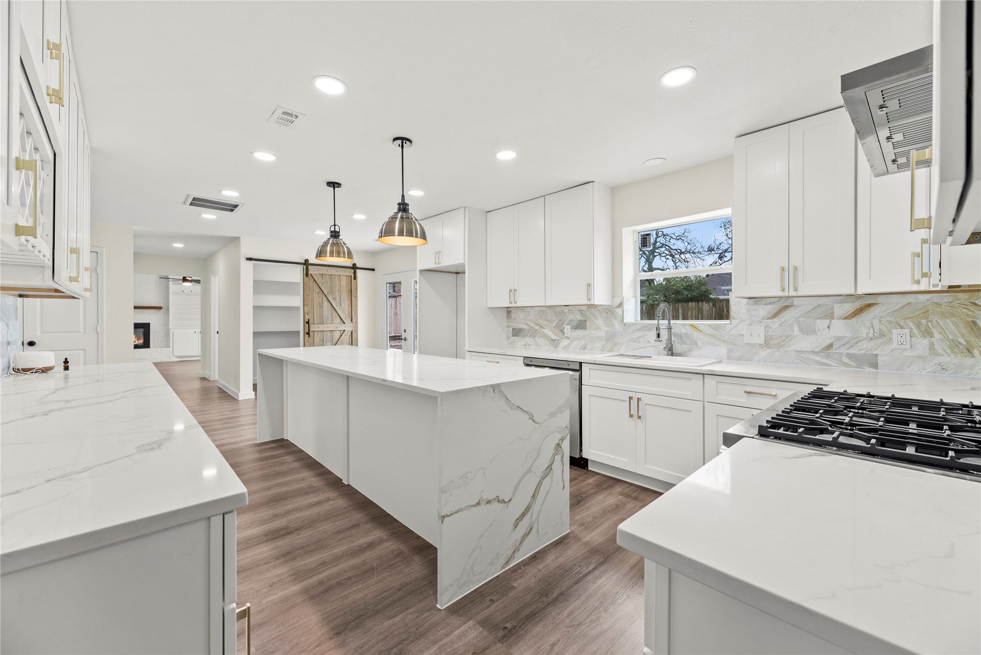 12551 Honeywood Trail, Houston, TX 77077 Gorgeous waterfall edge island with pendant lighting.