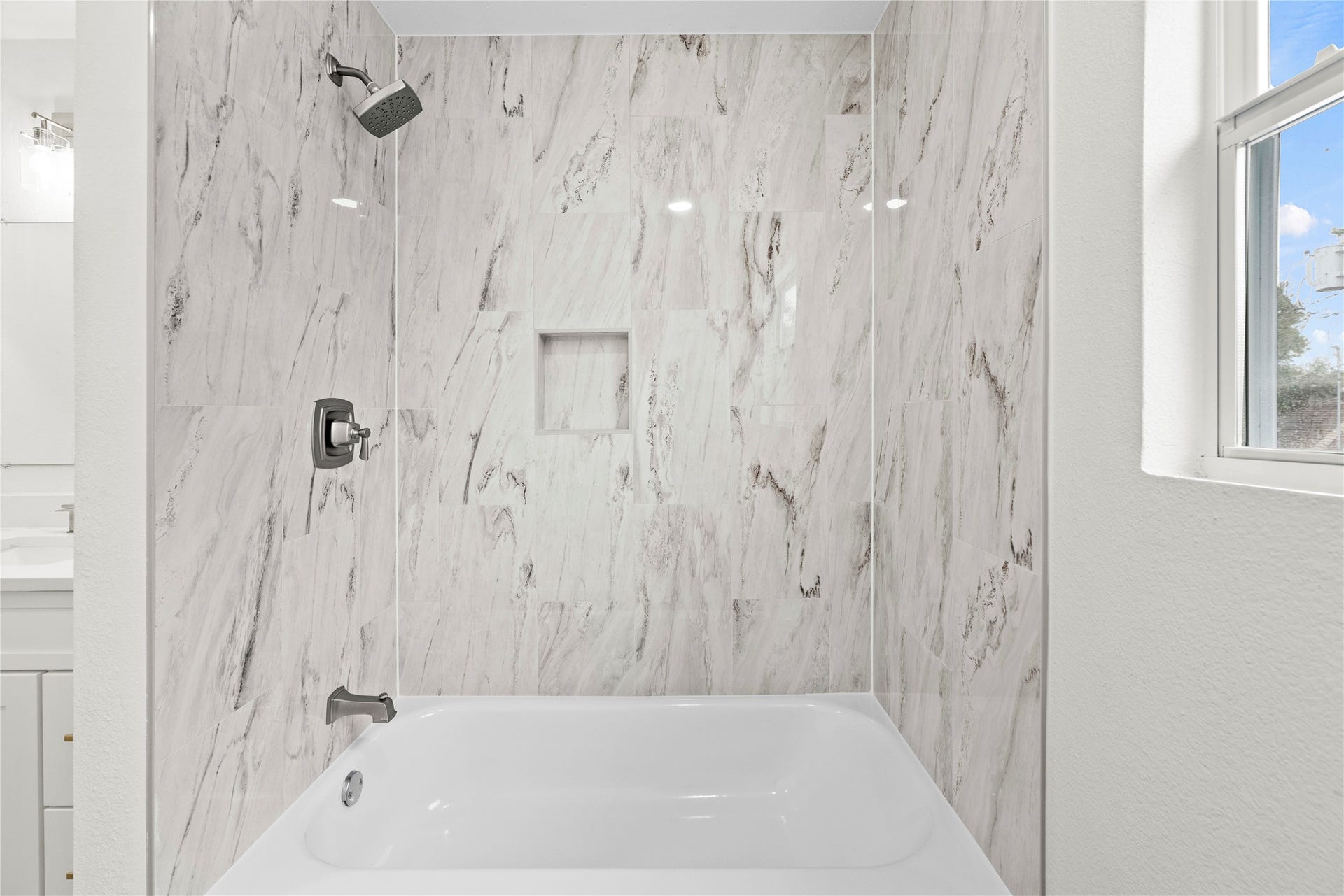 12551 Honeywood Trail, Houston, TX 77077 Tub/shower combination in the upstairs secondary bathroom.