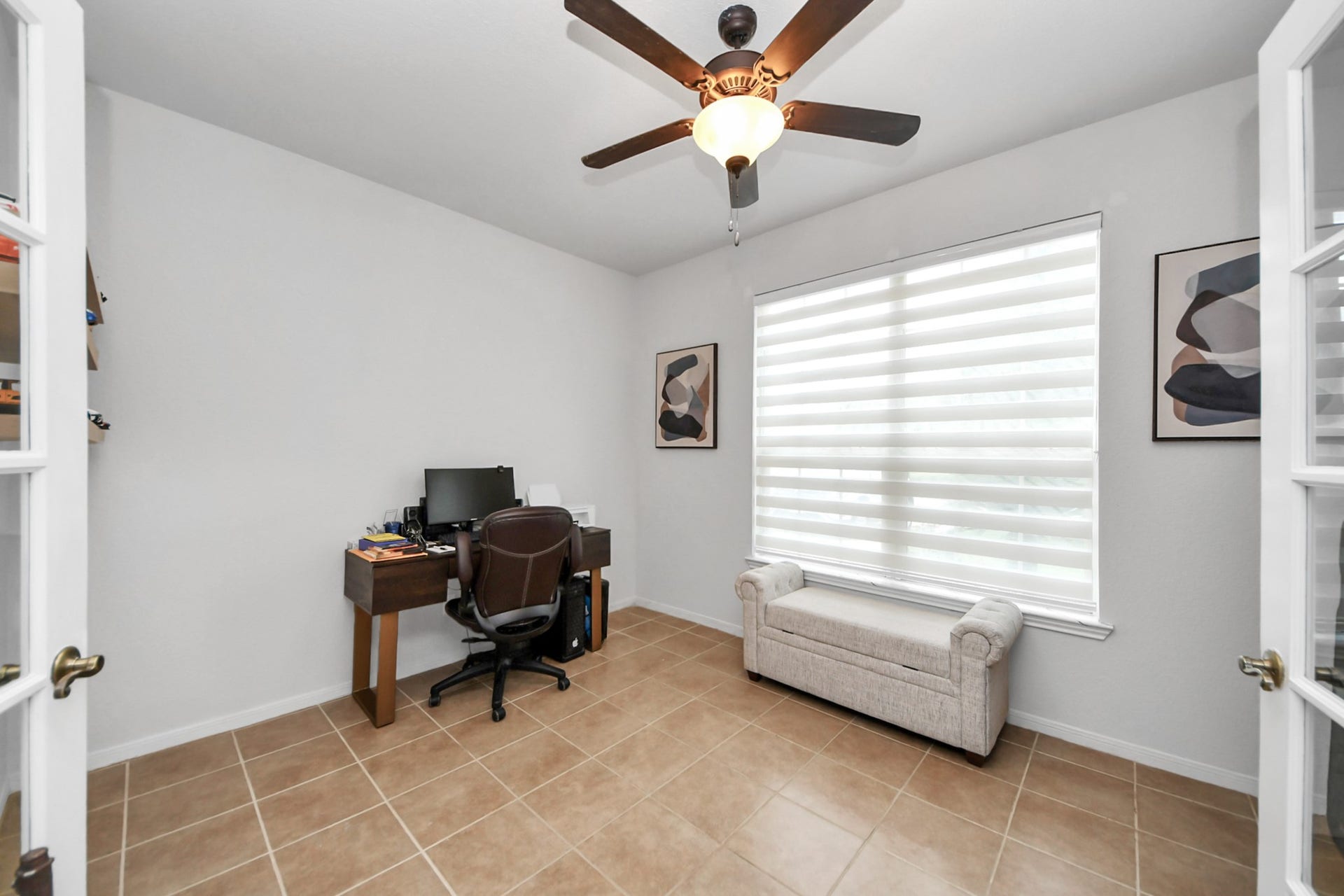 8519 E Windhaven Terrace Trail, Cypress, TX 77433 home office with two pairs of doors, one with glass and one normal doors