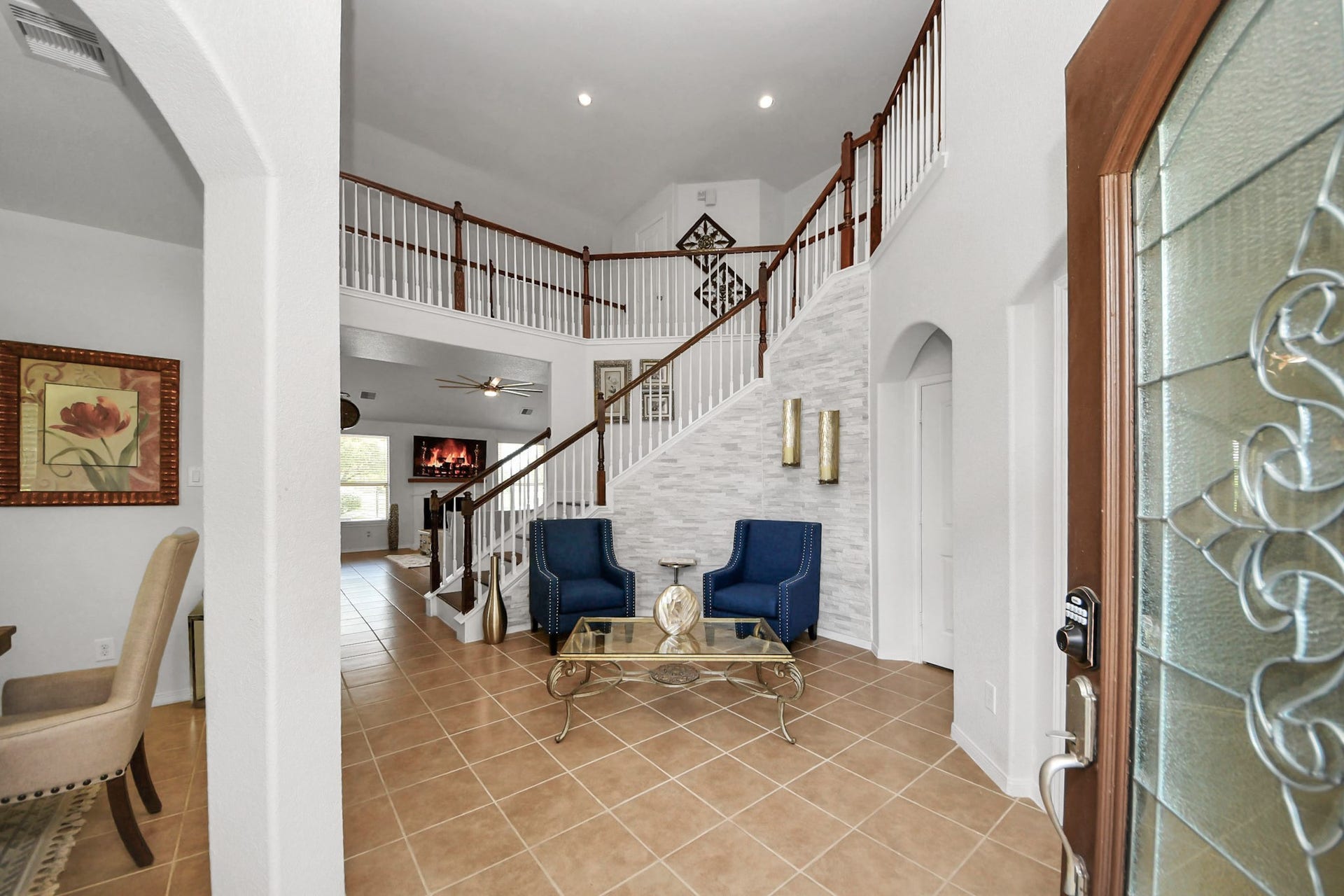 8519 E Windhaven Terrace Trail, Cypress, TX 77433 Grand foyer with soaring ceiling and an elegant staircase welcomes you into this stunning lakefront home