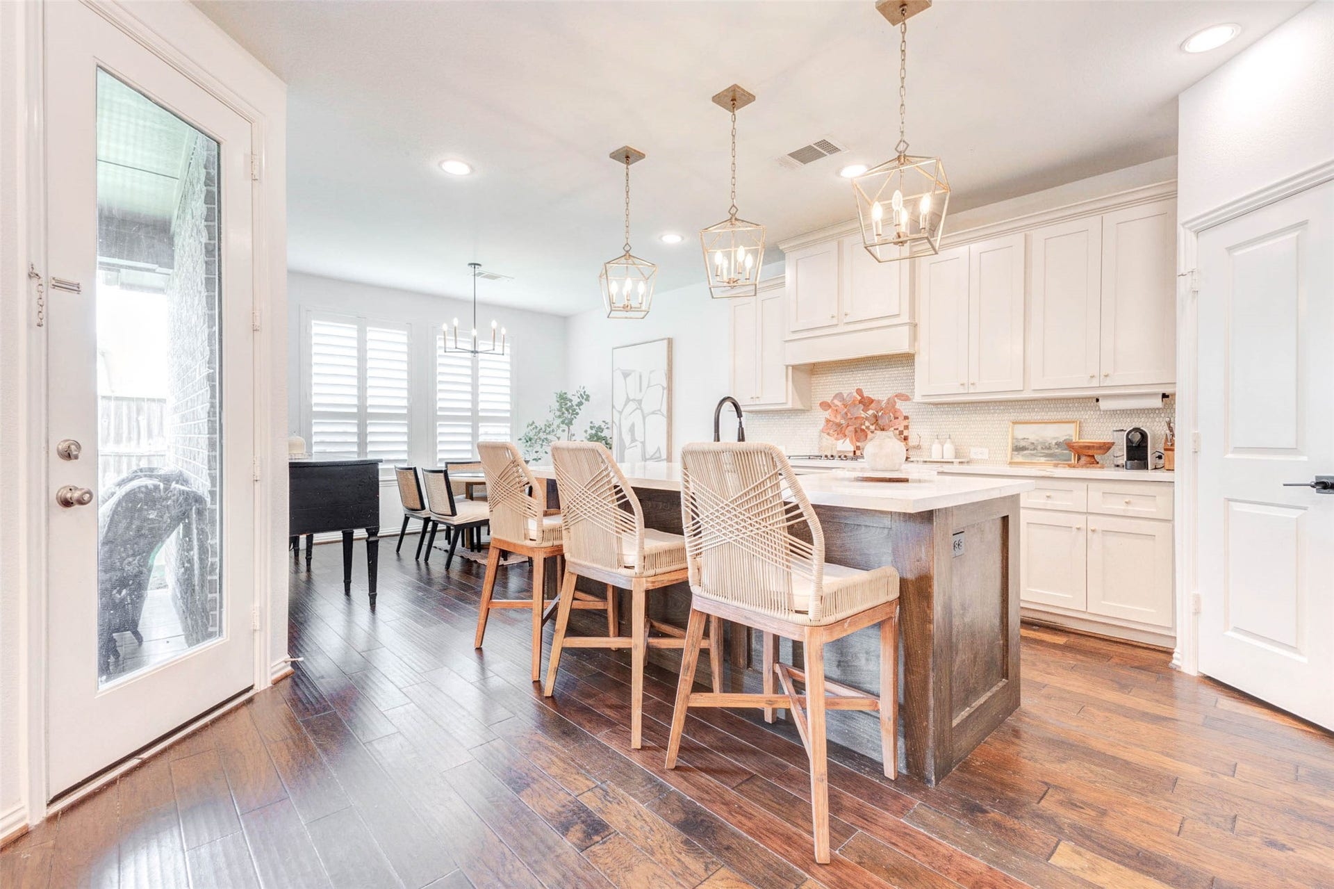 The heart of the home, this chef-inspired upgraded kitchen features a large central island perfect for seating and entertaining. Elegant pendant lighting highlights the space, while abundant upgraded cabinetry provides excellent storage. The open layout connects seamlessly to the dining area, allowing for easy hosting. Bright, clean finishes and thoughtful design make this kitchen both functional and visually stunning.