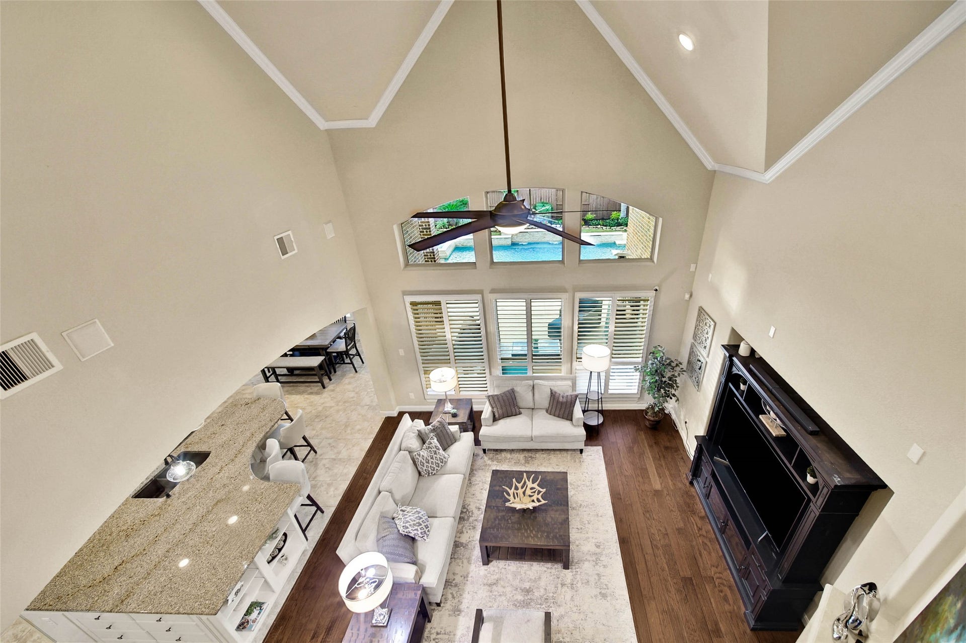 5318 Briarcliff Lane, Fulshear, TX 77441 An upstairs vantage point offers a beautiful perspective of the spacious living room below, highlighting its open design and soaring ceilings.