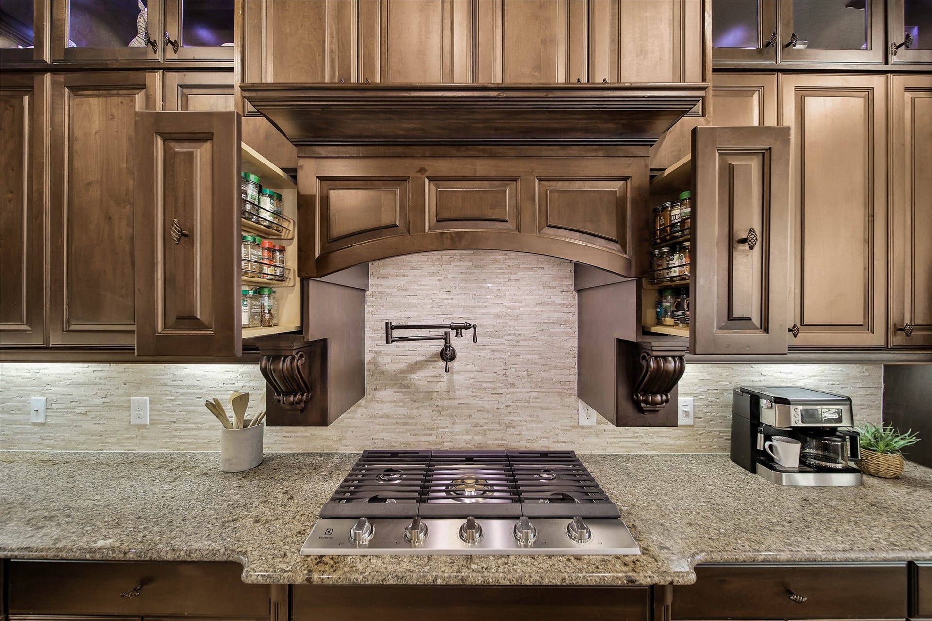 5318 Briarcliff Lane, Fulshear, TX 77441 Two convenient pull-out spice racks on either side of the cooktop keep your favorite seasonings within easy reach when preparing your famous recipes.... AND dont forget the handy pot filler above the cooktop, adding a touch of chef-inspired luxury and everyday practicality to this exceptional kitchen! Electrolux Cooktop (2026).