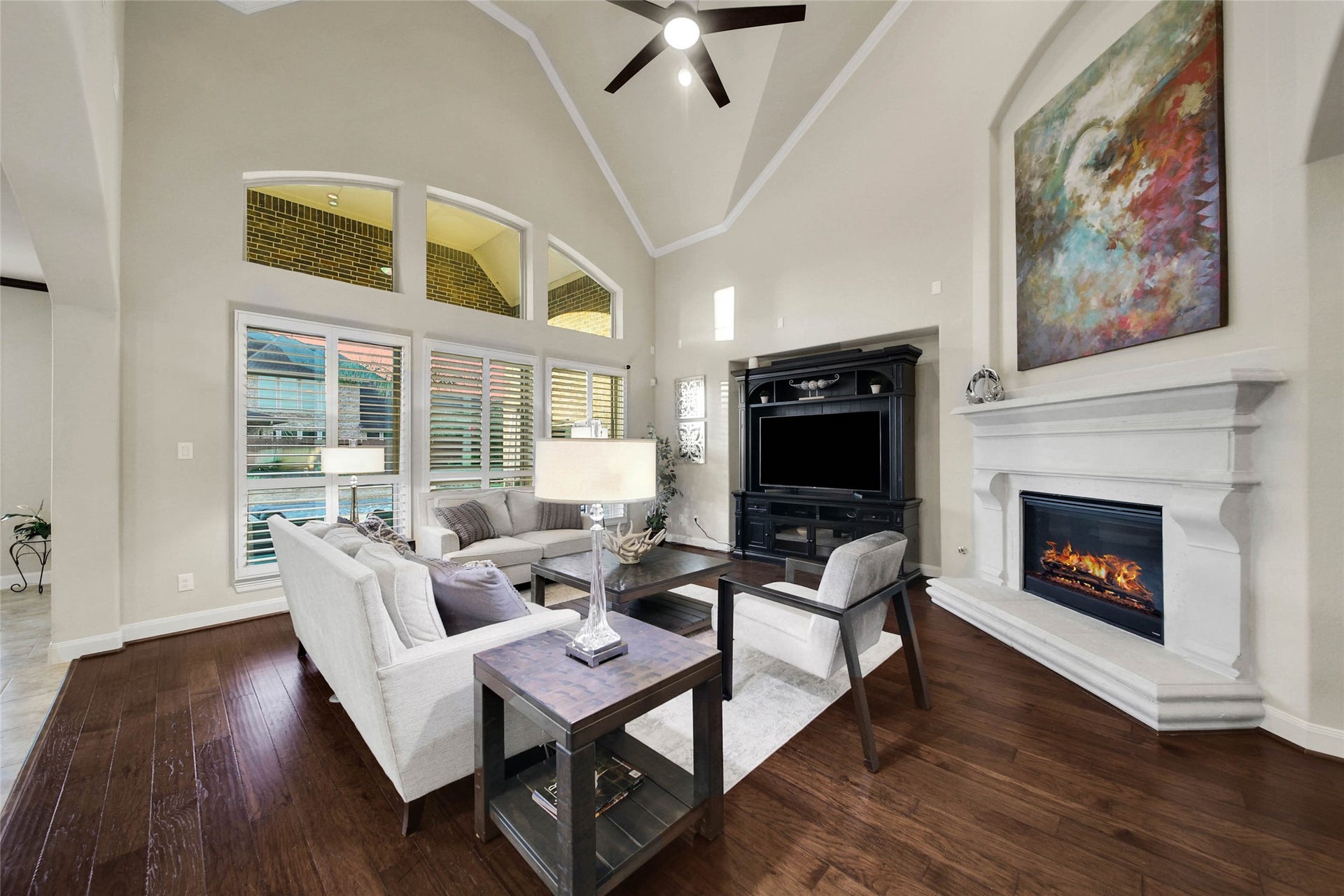 5318 Briarcliff Lane, Fulshear, TX 77441 The cast-stone fireplace with gas logs creates a stunning focal point in the living room, adding character and warmth to the space.