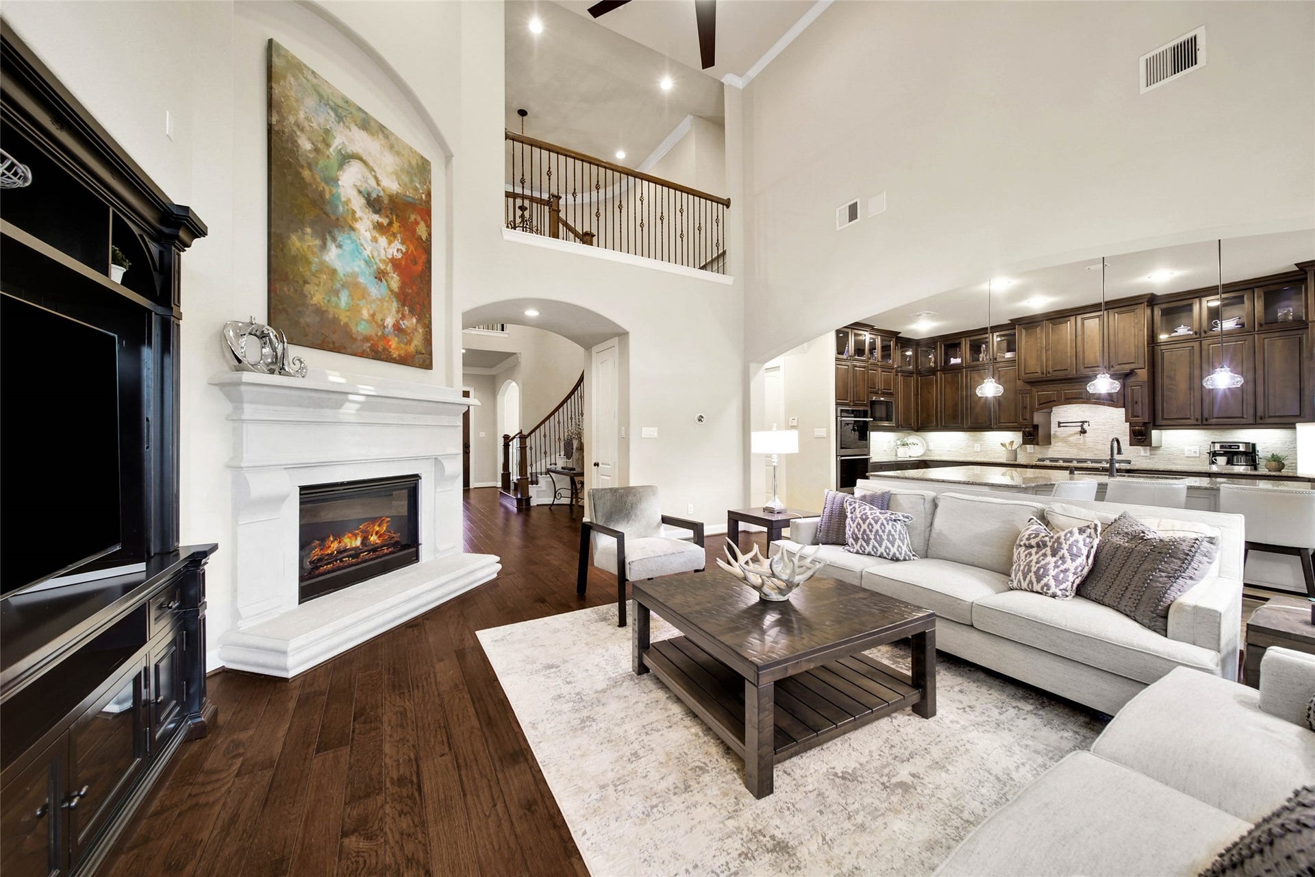 5318 Briarcliff Lane, Fulshear, TX 77441 The spacious living room boasts soaring ceilings that enhance the open, airy feel, while built-in sound wiring sets the stage for the perfect entertainment experience.