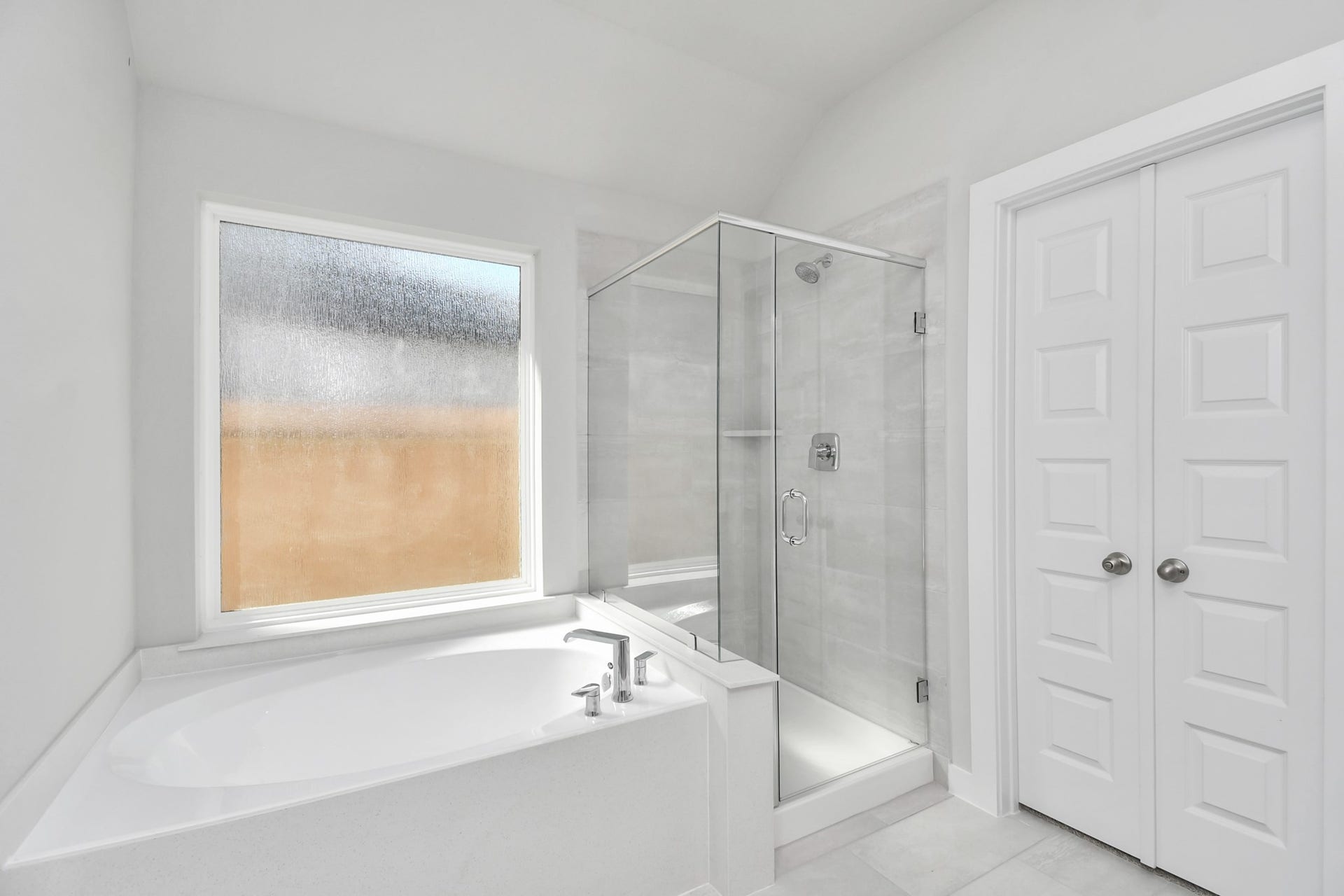 16007 Sycamore Maple Lane, Cypress, TX 77429 Indulge in a spa-like retreat within the confines of this primary bathroom. Delight in a spacious walk-in shower enveloped in stylish tile surround and unwind in a separate garden tub adorned with custom detailing. Sample photo of completed home with similar floor plan. Actual colors and selections may vary.