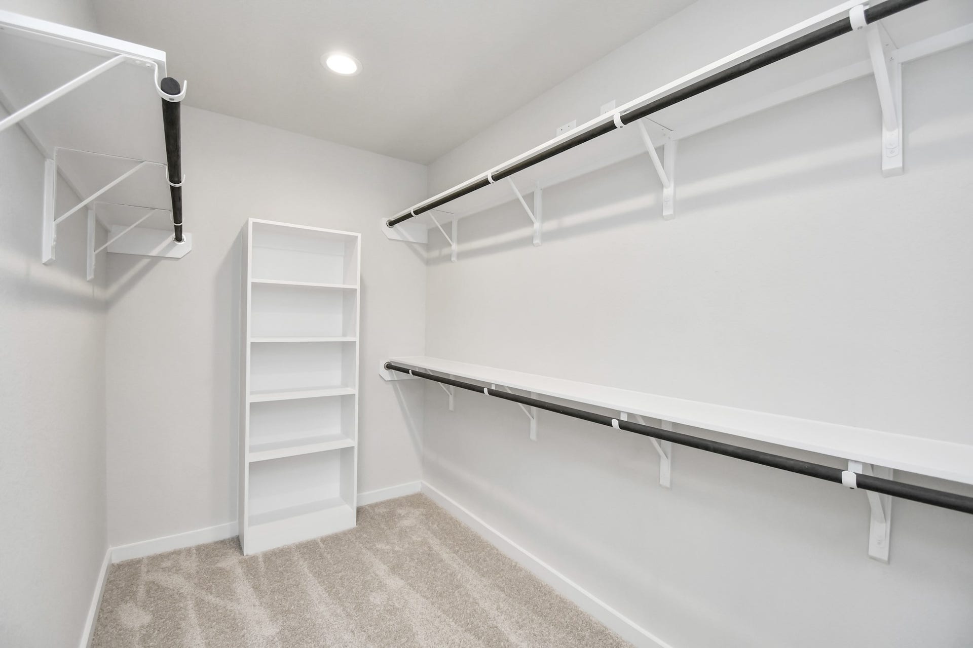 16007 Sycamore Maple Lane, Cypress, TX 77429 Walk-in closet that epitomizes luxury and practicality. This generously sized space features built-in shelving, offering abundant room for impeccable organization. High ceilings and recessed lighting create a bright and welcoming ambiance. Sample photo of completed home with similar floor plan. Actual colors and selections may vary.