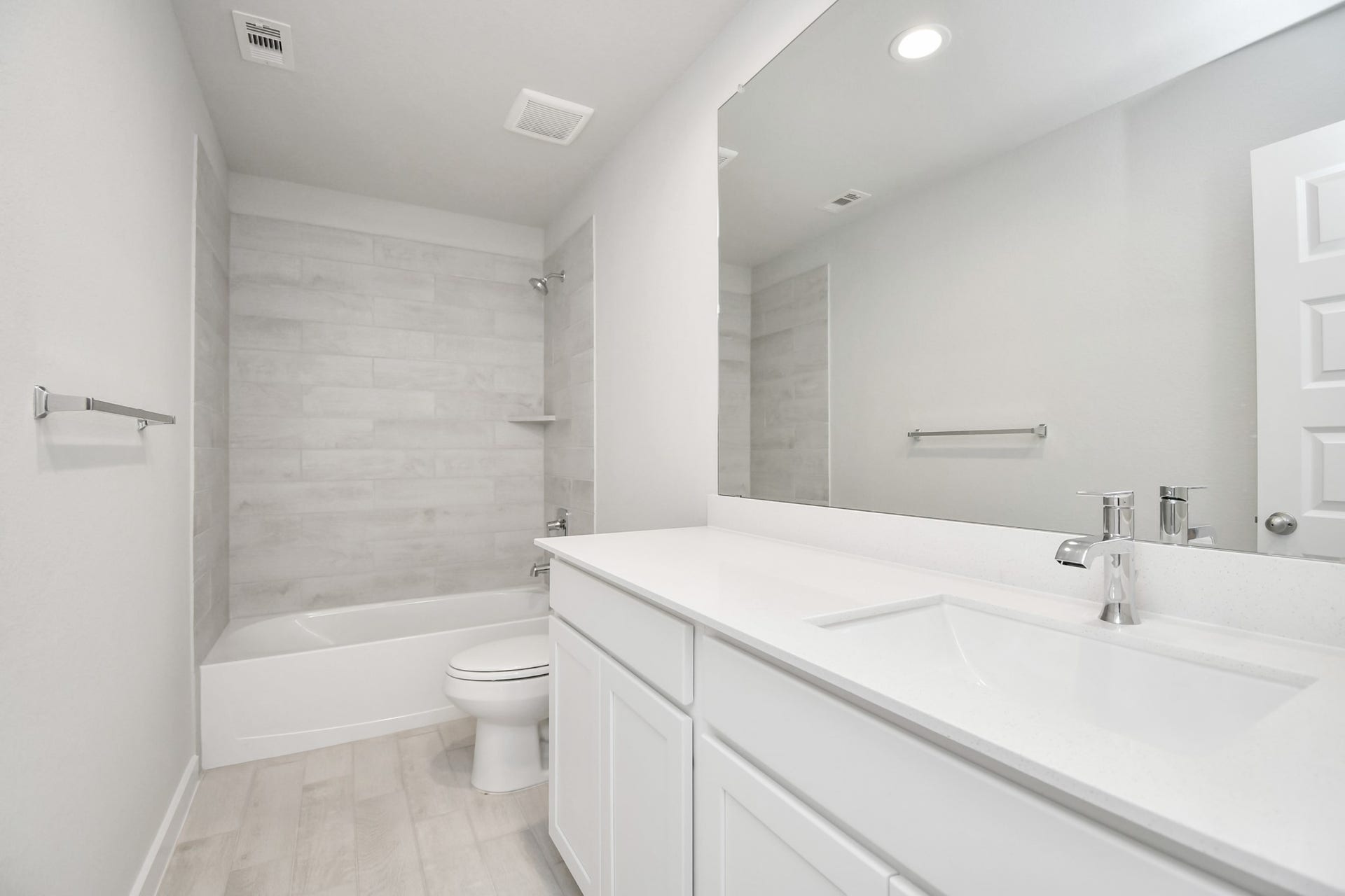 16007 Sycamore Maple Lane, Cypress, TX 77429 Secondary bath features tile flooring, bath/shower combo with tile surround, light stained wood cabinets, beautiful light countertop. Sample photo of completed home with similar floor plan. Actual colors and selections may vary.