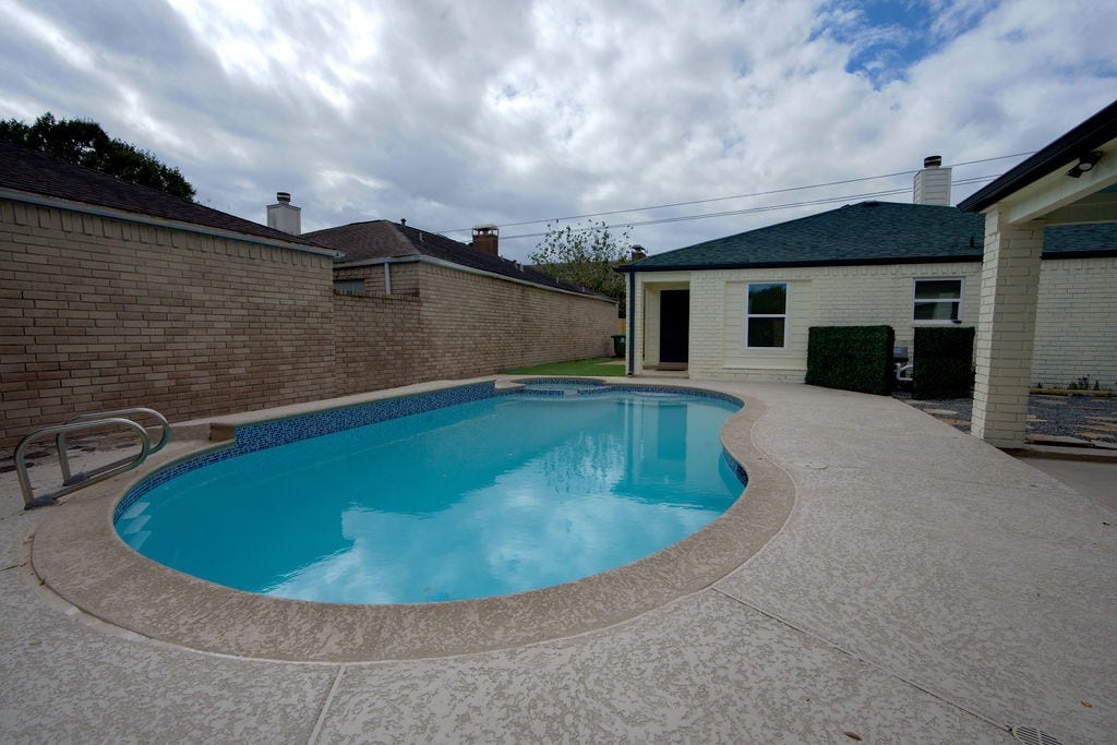Enjoy a refreshing dip in this inviting backyard pool, surrounded by a spacious deck perfect for entertaining or relaxing.